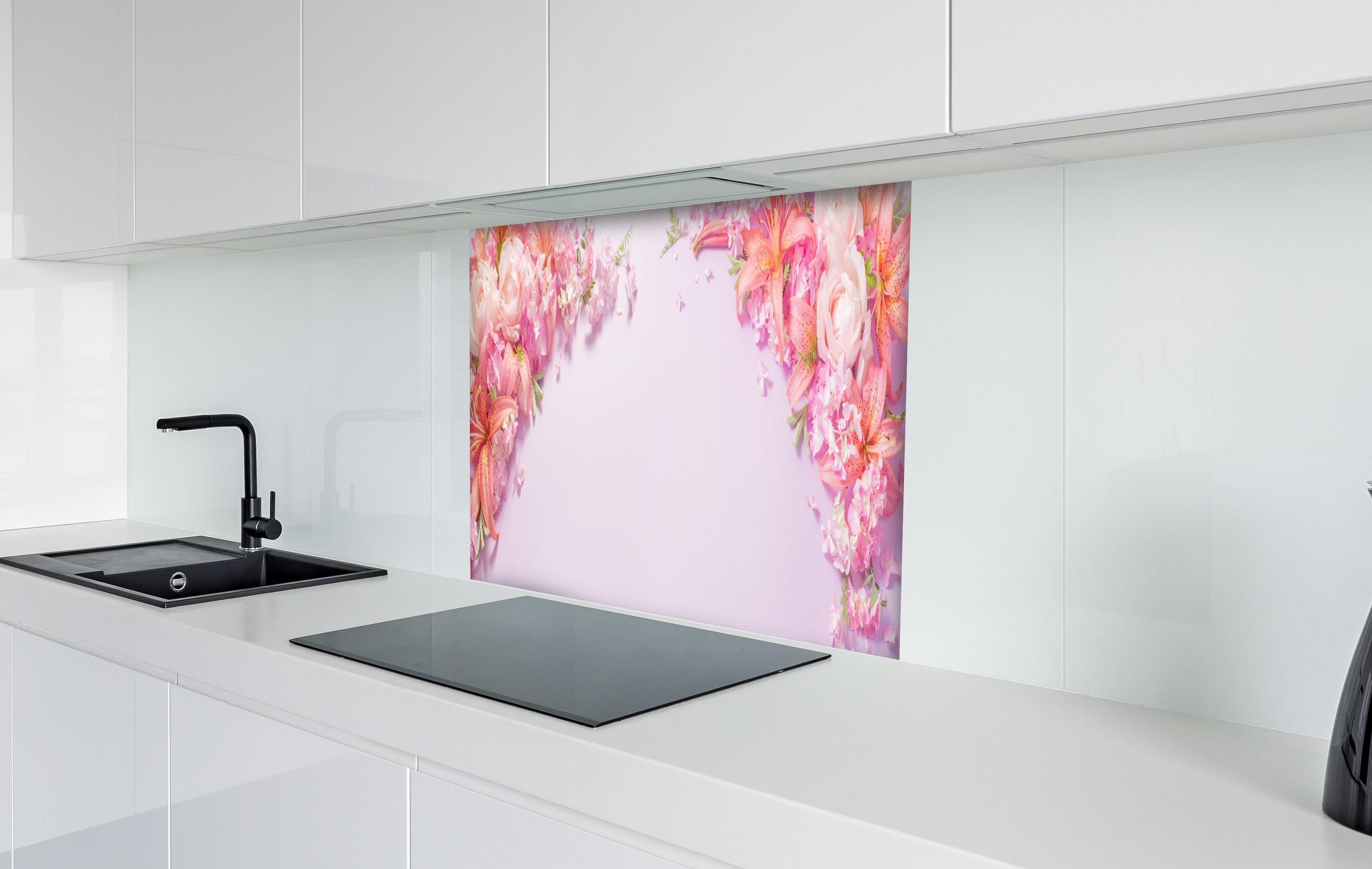 Spritzschutz - Sommerliche Blumenarrangements auf Papier hinter einem Cerankochfeld zwischen Holz-Kochutensilien