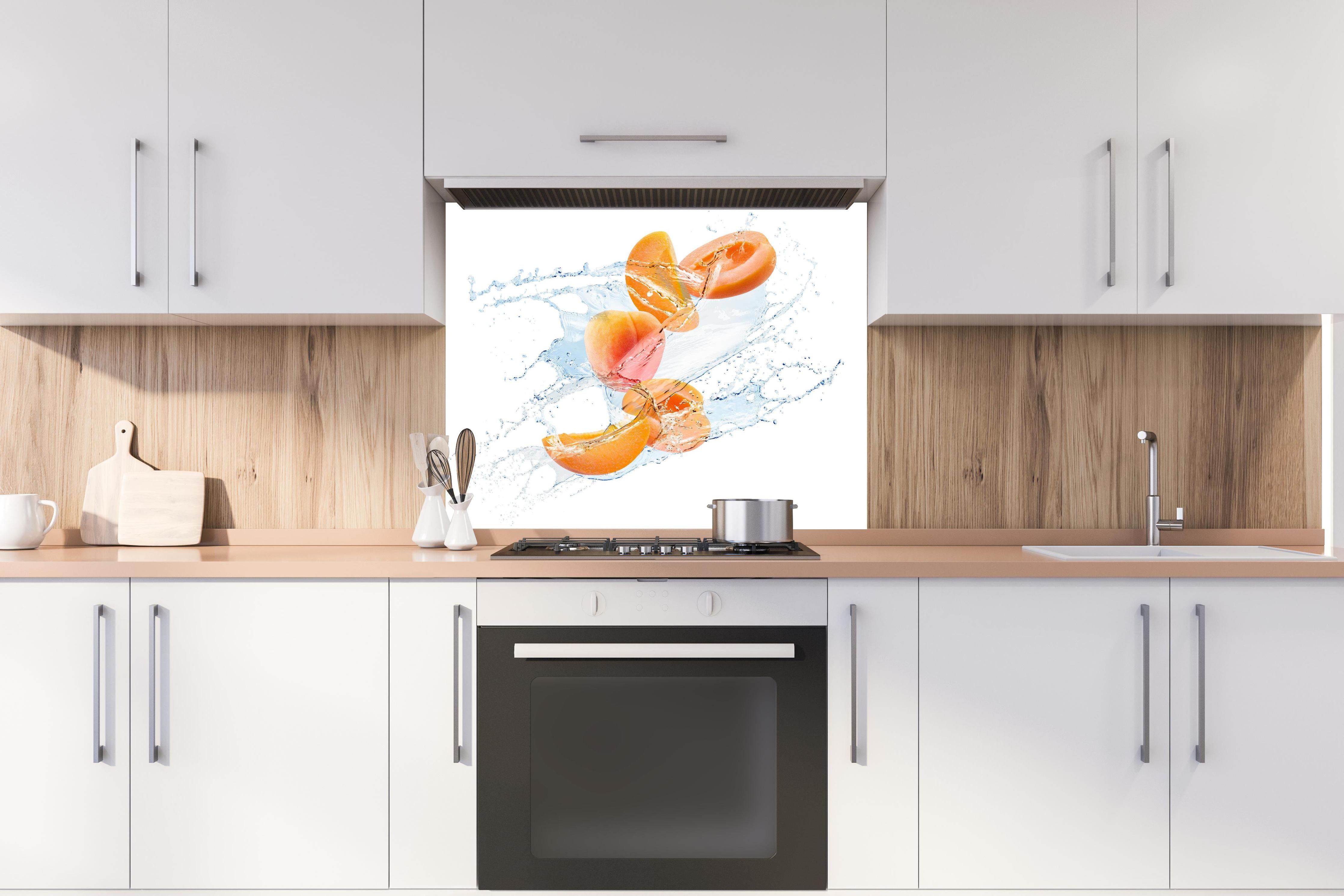 Spritzschutz - Spritzige Aprikosen hinter einem Cerankochfeld zwischen Holz-Kochutensilien
