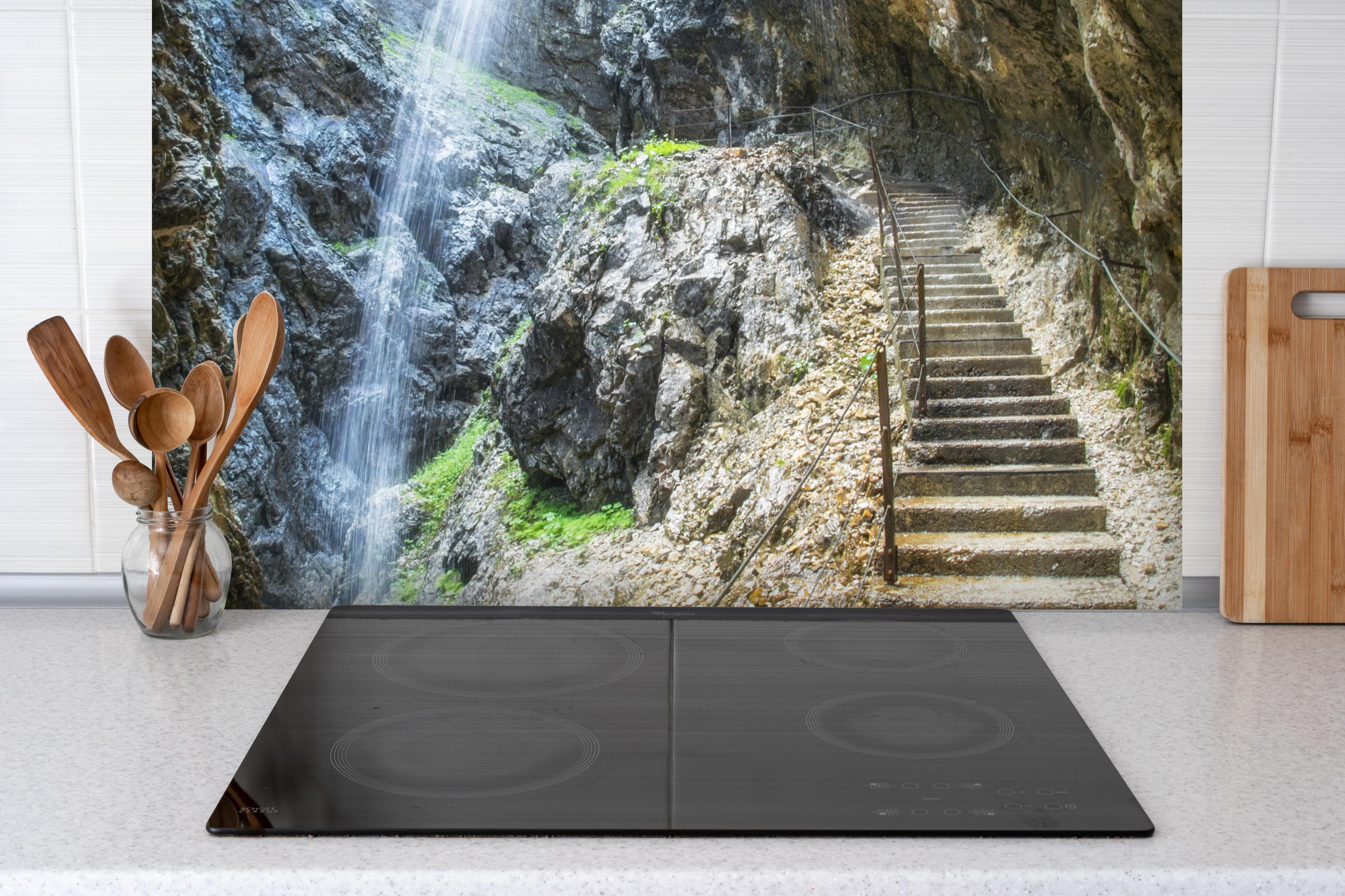 Spritzschutz - Antike Steintreppen mit Wasserfall hinter einem Cerankochfeld zwischen Holz-Kochutensilien