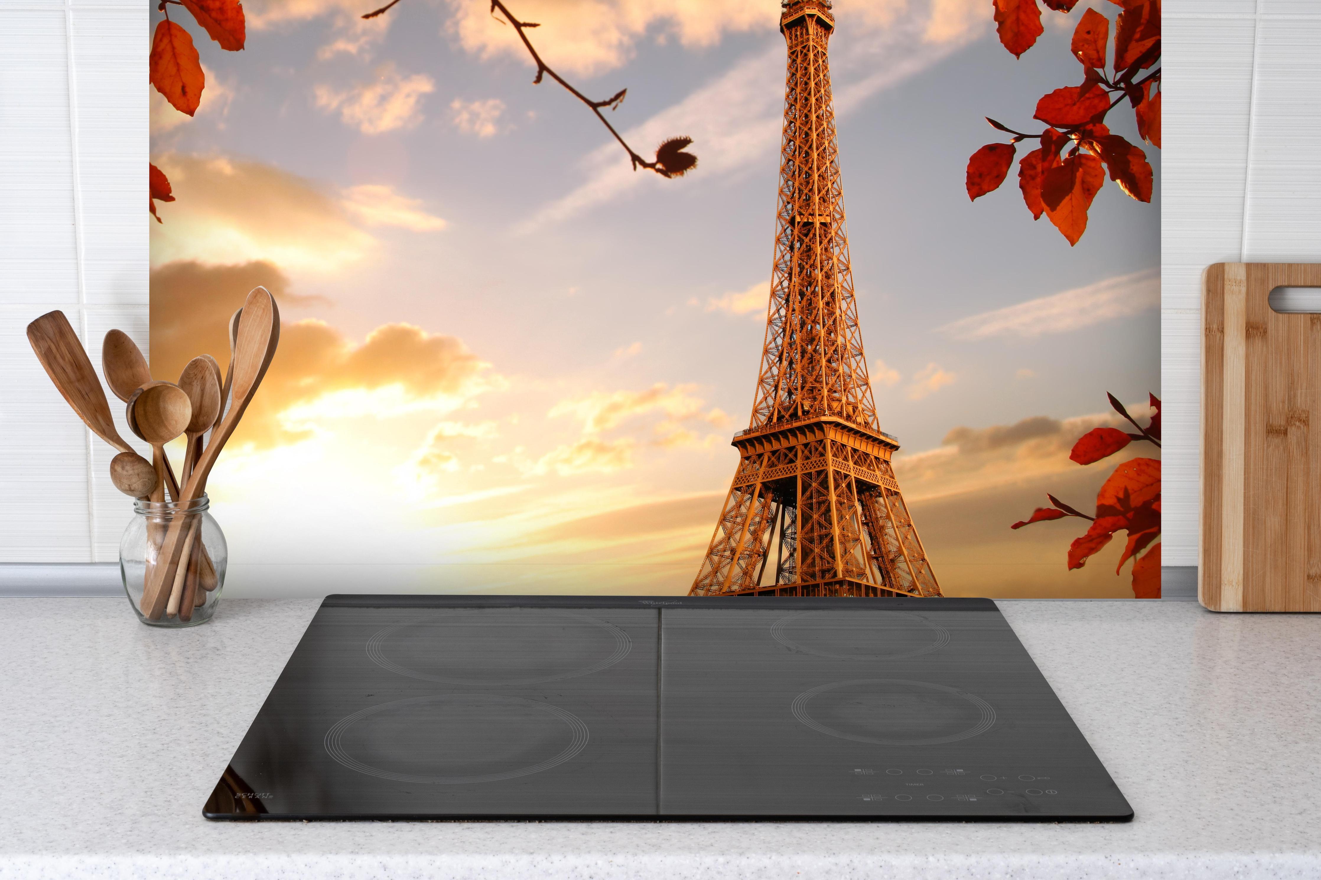 Spritzschutz - Eiffelturm mit Herbstlaub in Paris hinter einem Cerankochfeld zwischen Holz-Kochutensilien