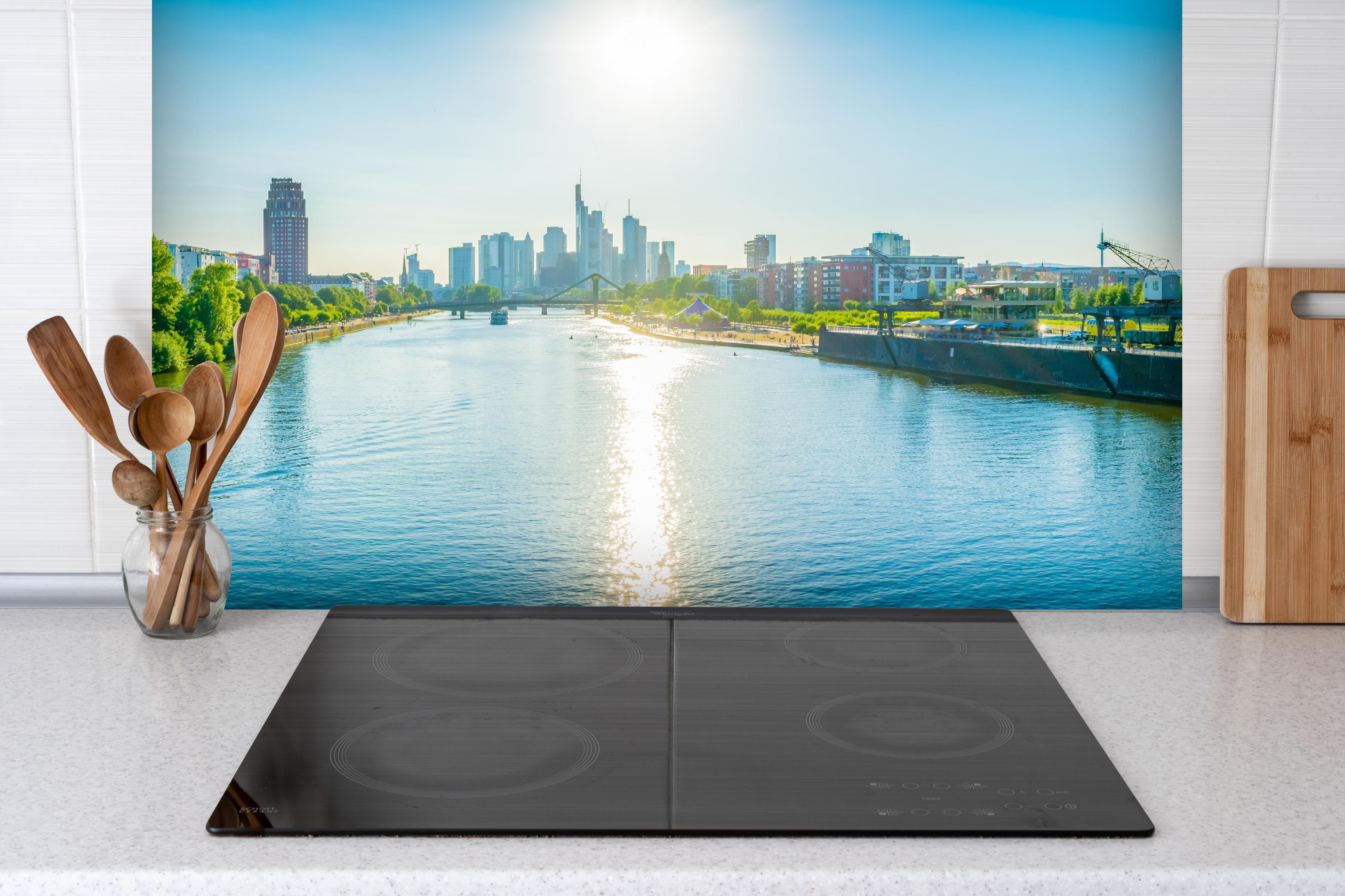 Spritzschutz - Frankfurt EZB bei Tag hinter einem Cerankochfeld zwischen Holz-Kochutensilien