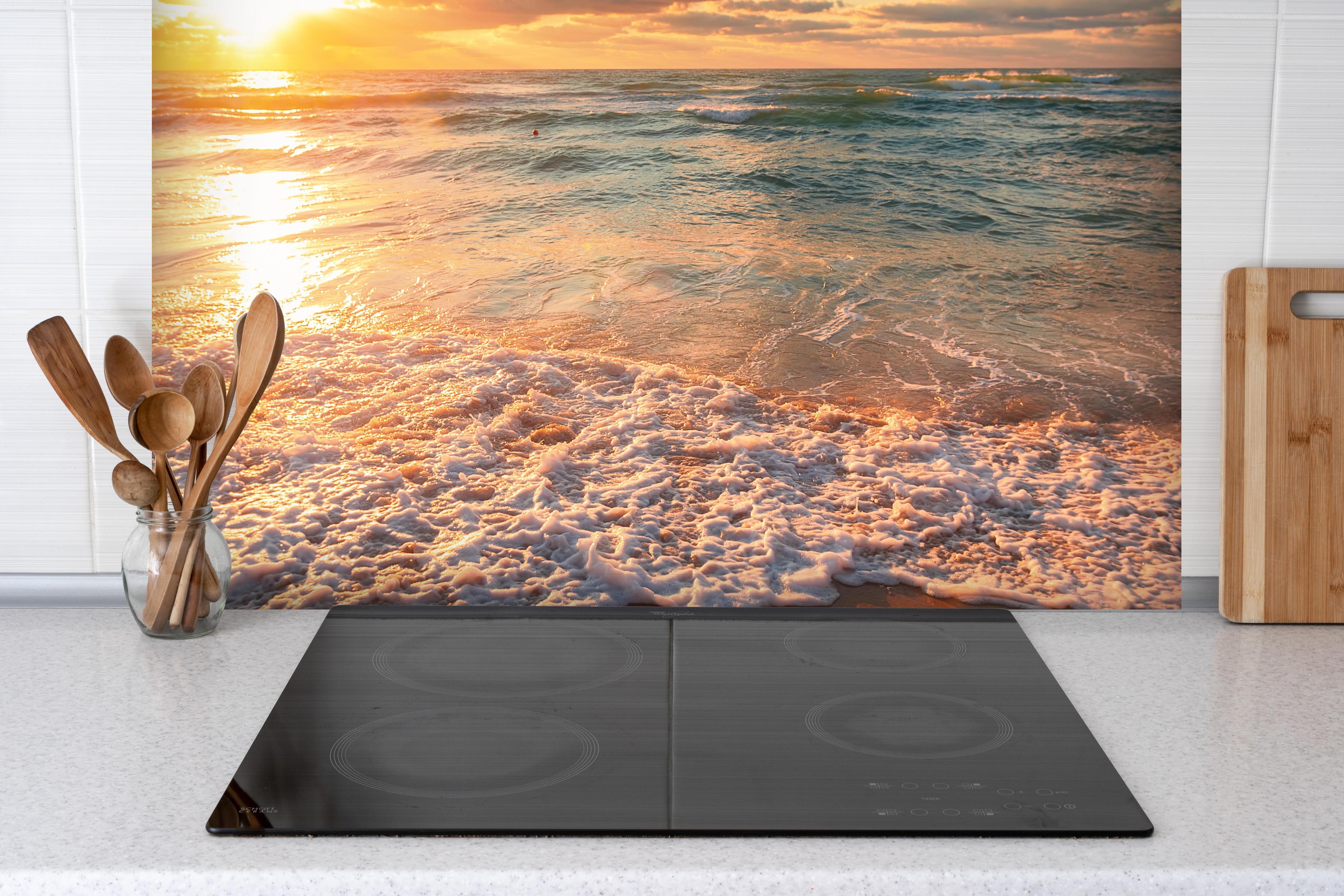 Spritzschutz - Schönes Sonnenlicht am Strand hinter einem Cerankochfeld zwischen Holz-Kochutensilien