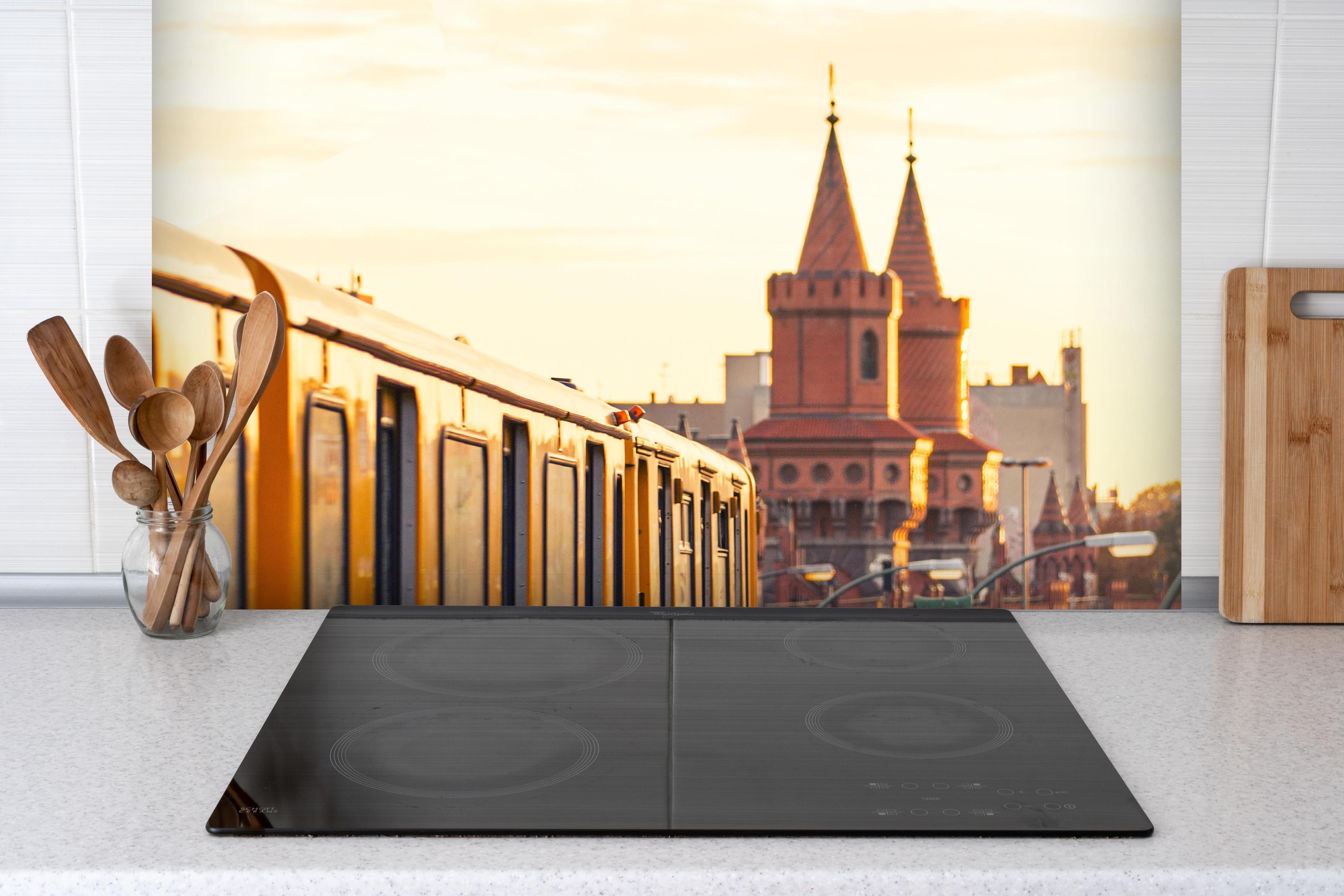 Spritzschutz - Sonnige Berlin Oberbaumbrücke hinter einem Cerankochfeld zwischen Holz-Kochutensilien