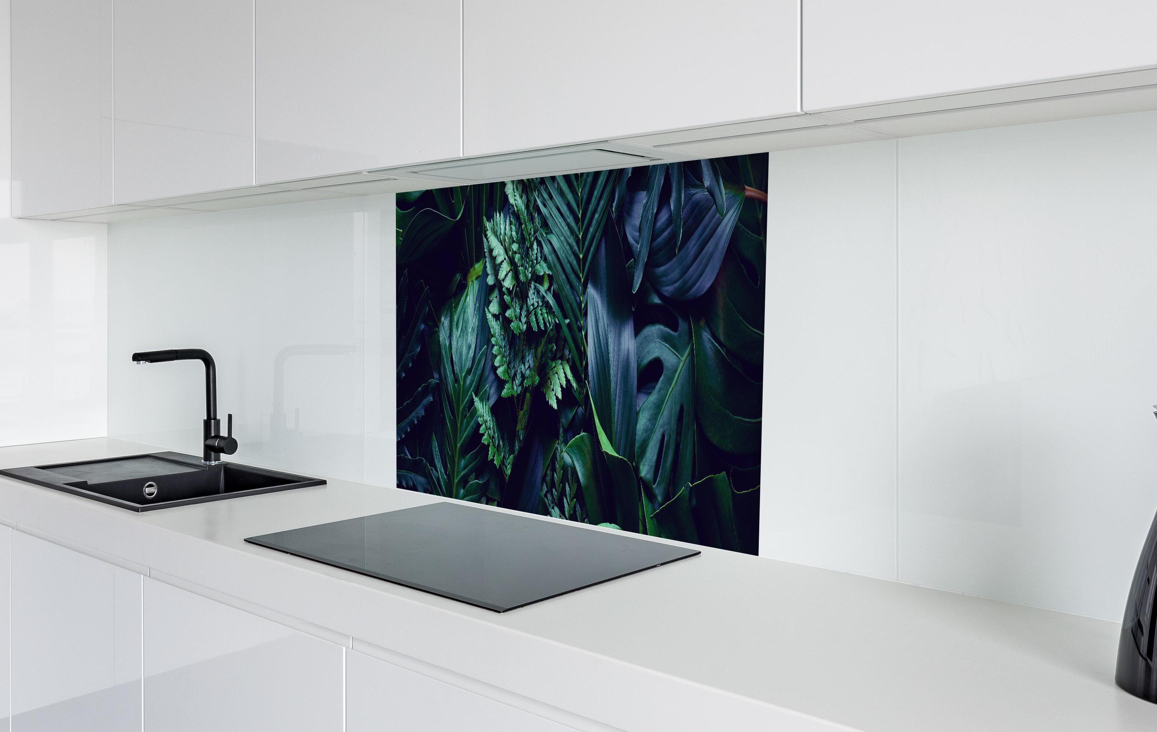 Spritzschutz - Tropischen grüne Blätter bei Nacht in weißer Hochglanz-Küche hinter einem Cerankochfeld