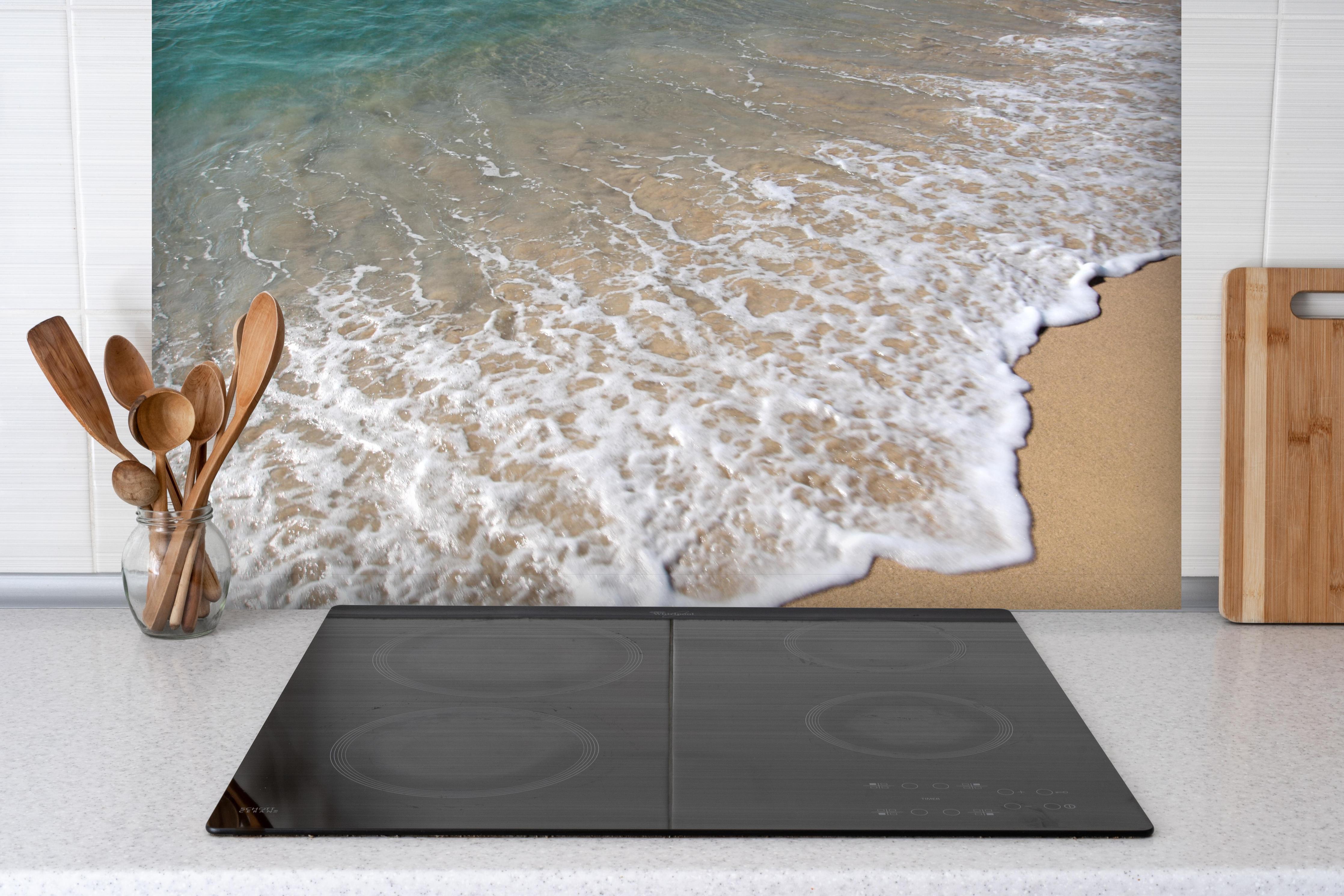 Spritzschutz - friedlicher Strand in Grieschenland hinter einem Cerankochfeld zwischen Holz-Kochutensilien