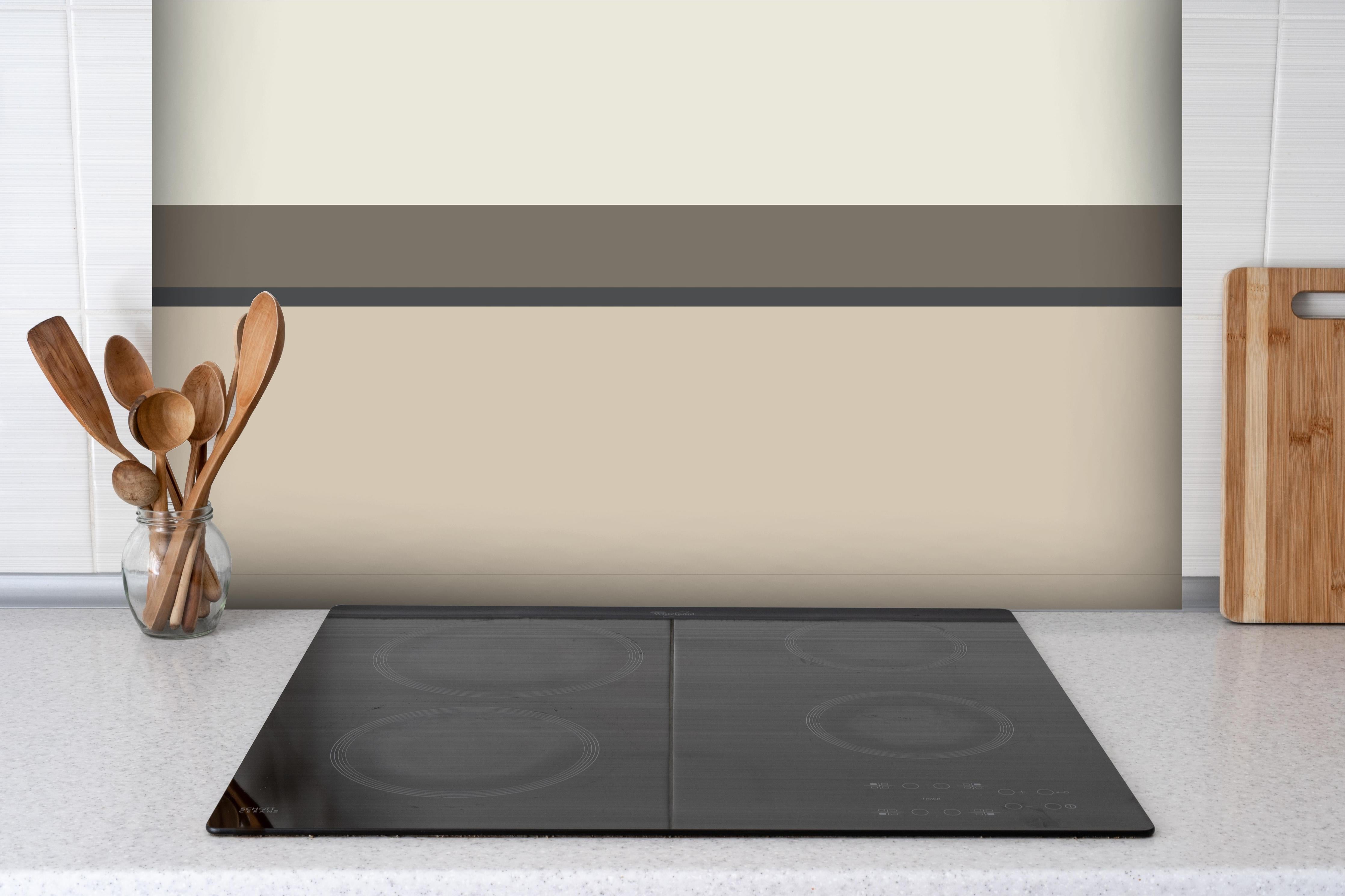 Spritzschutz - The Nudes - Horizontal - Toffee hinter einem Cerankochfeld zwischen Holz-Kochutensilien