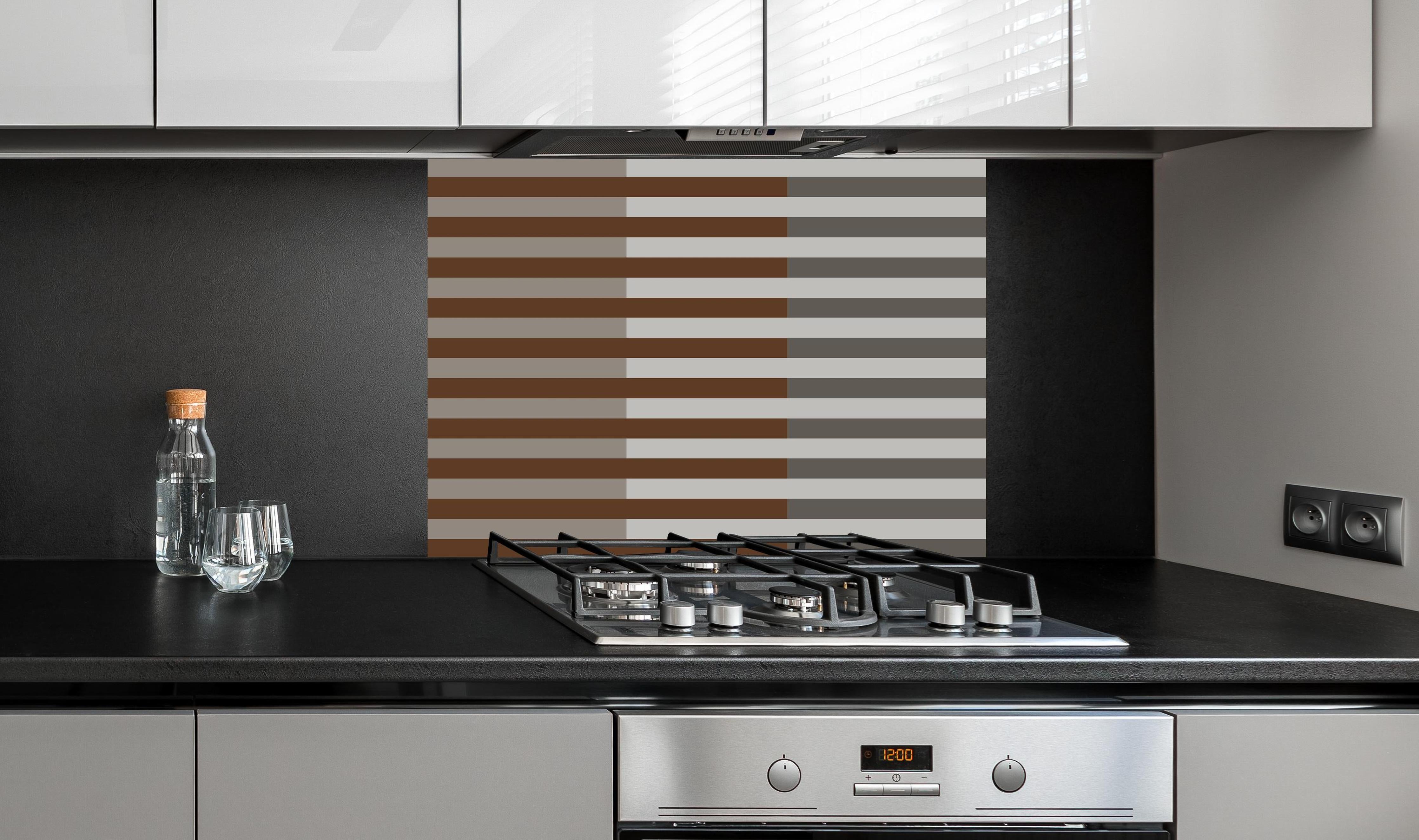 Spritzschutz - The Nudes - Multy Stripes - Ash hinter einem Cerankochfeld zwischen Holz-Kochutensilien