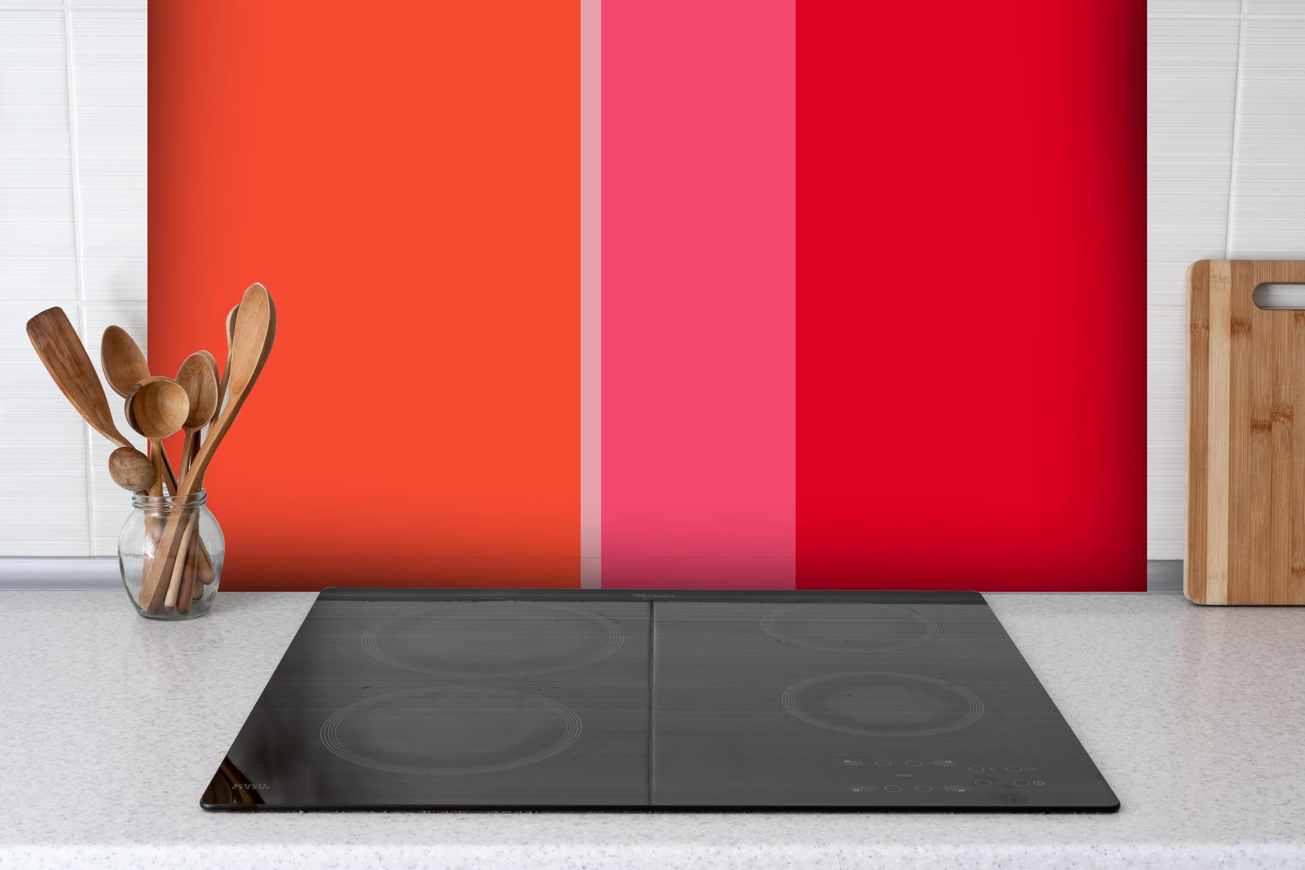 Spritzschutz - The Reds - Vertical - Strawberry hinter einem Cerankochfeld zwischen Holz-Kochutensilien