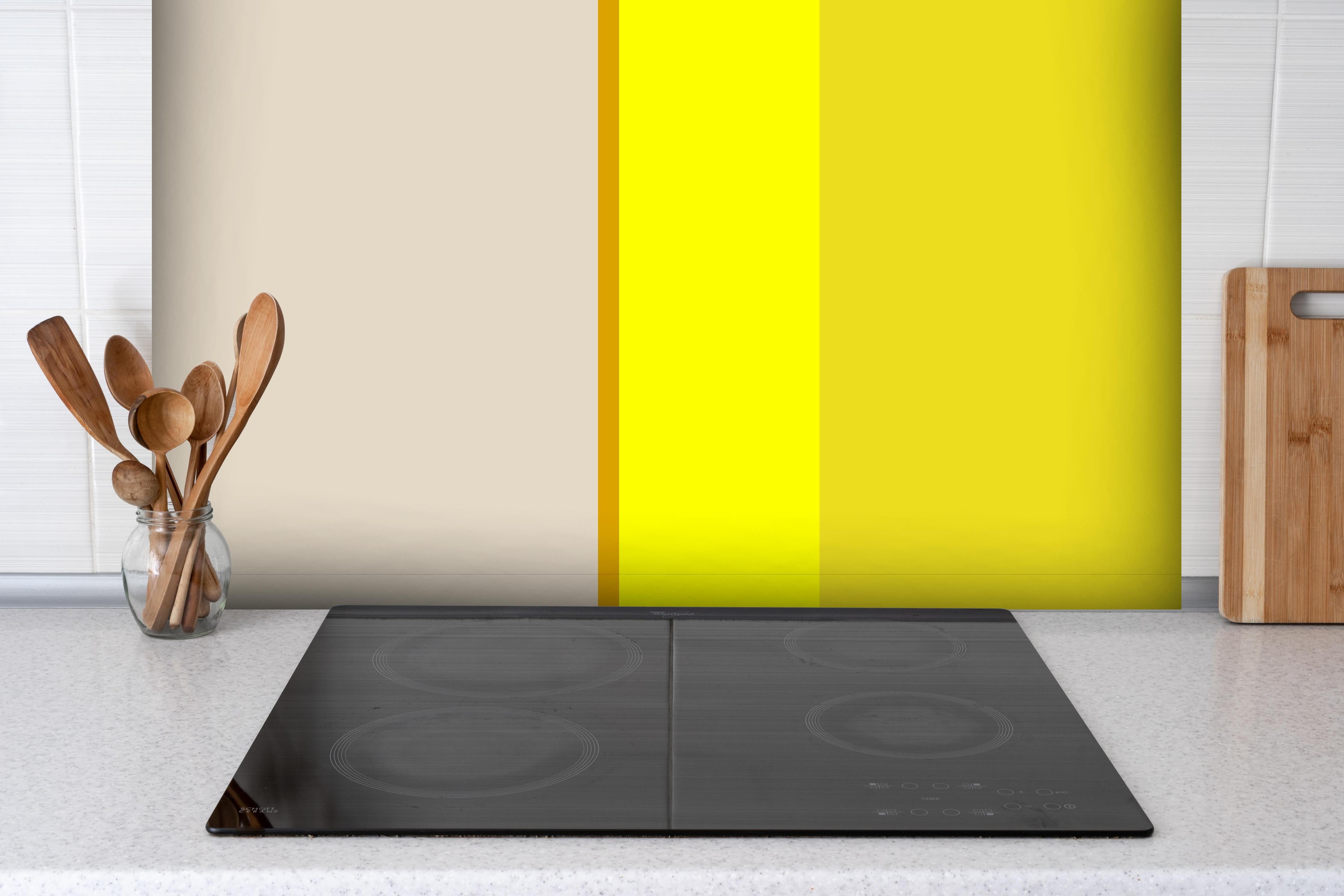 Spritzschutz - The Yellows - Vertical - Vanilla hinter einem Cerankochfeld zwischen Holz-Kochutensilien
