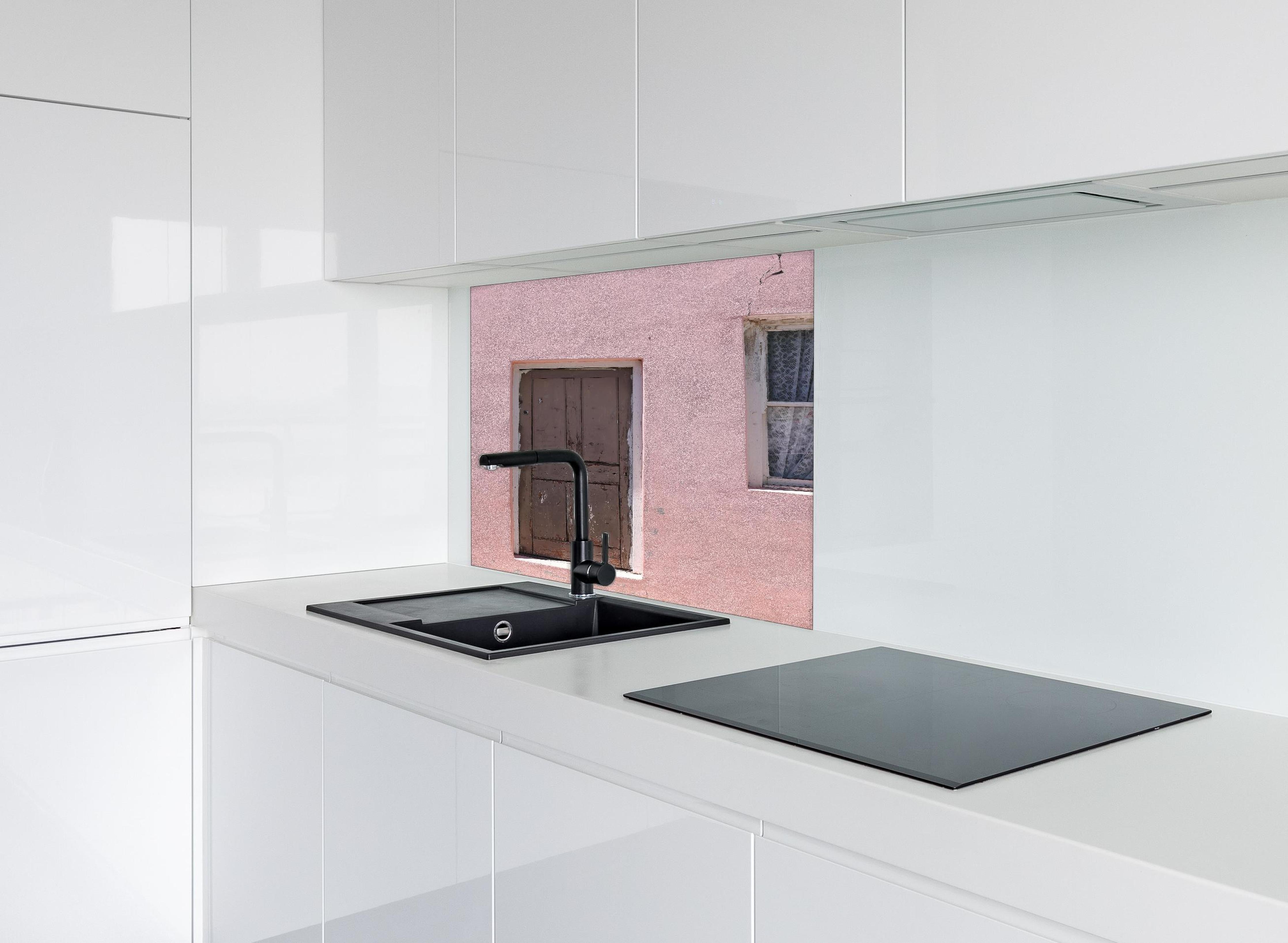 Spritzschutz - Verwitterte Holztür an rosa Bauernhaus hinter einem Cerankochfeld zwischen Holz-Kochutensilien