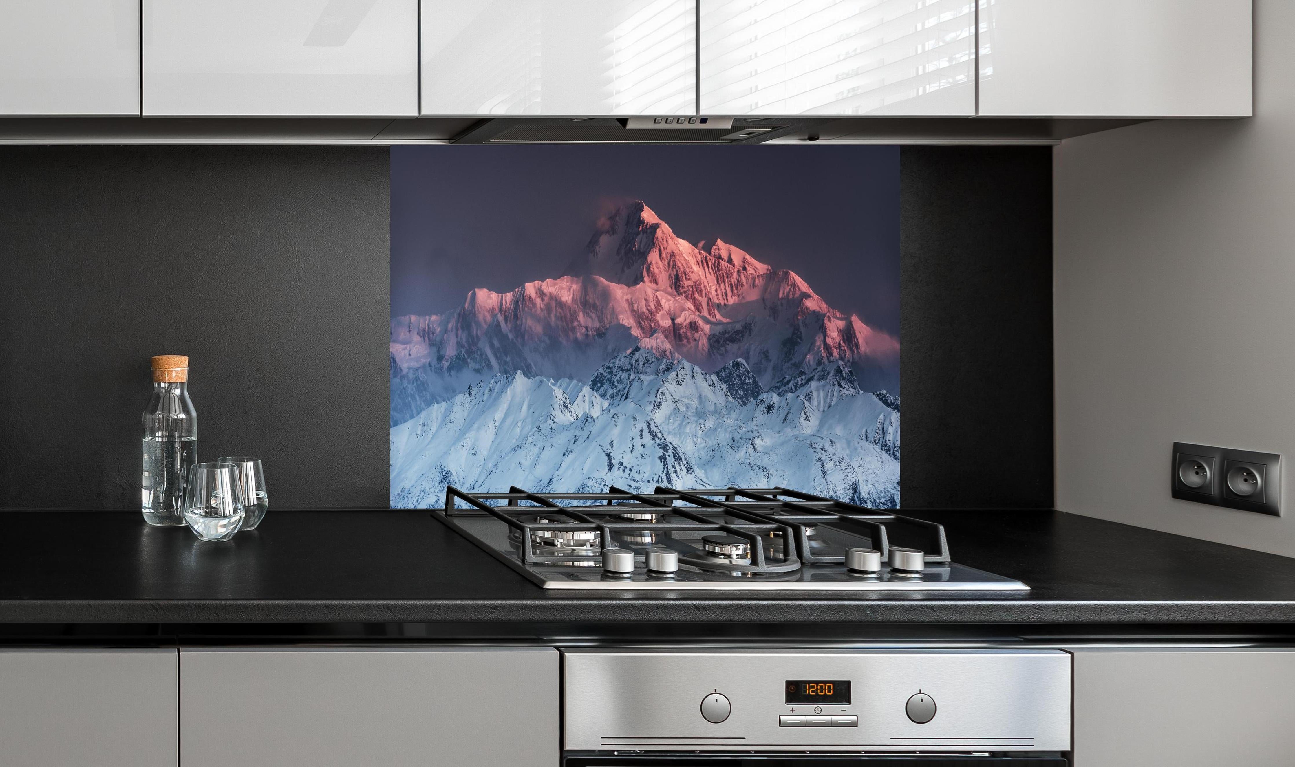 Spritzschutz - Winterliches Panorama des Mount Denali hinter einem Cerankochfeld zwischen Holz-Kochutensilien