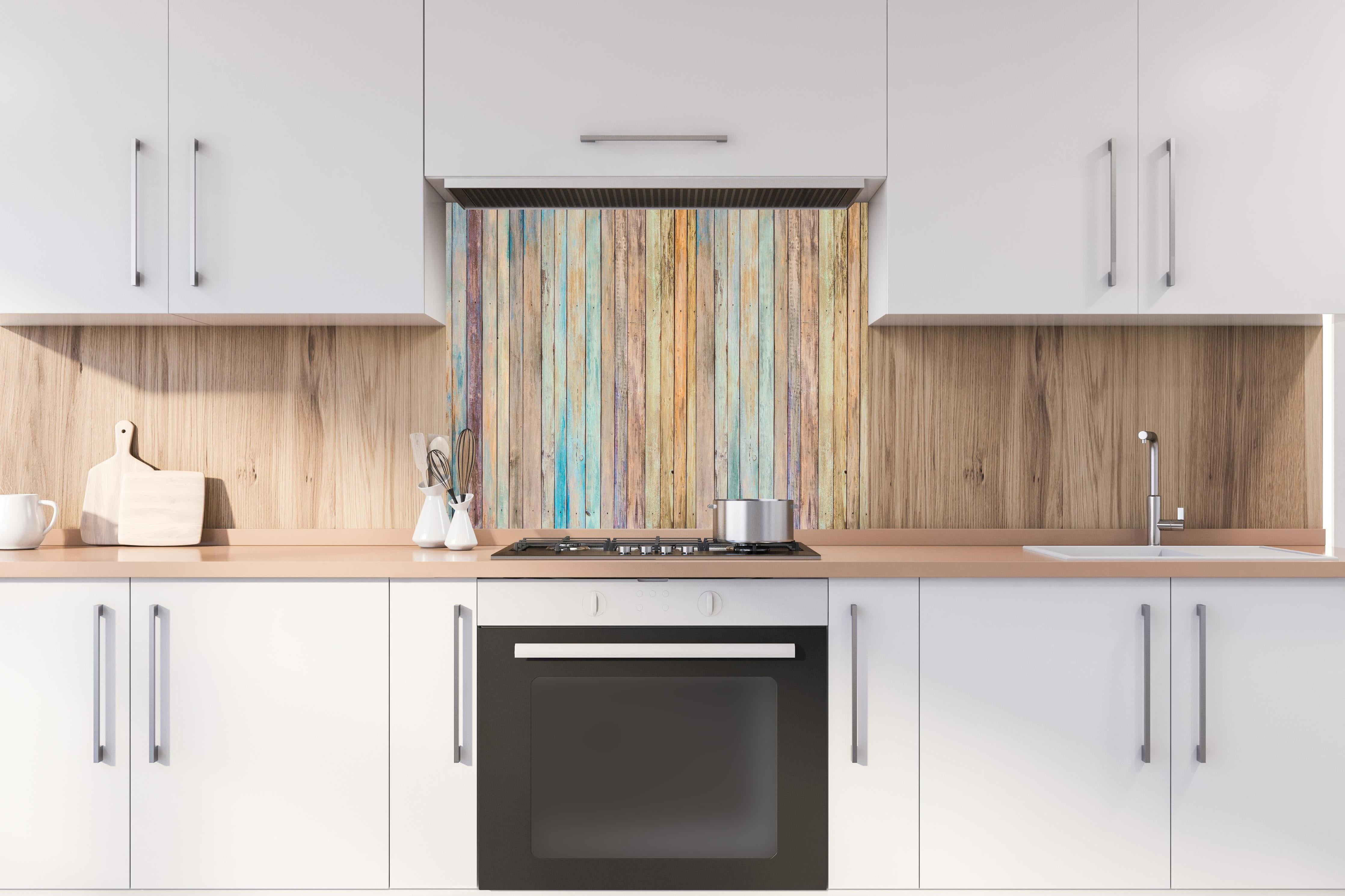 Spritzschutz - vielfarbiger Hintergrund - alte Holzplanken hinter einem Cerankochfeld zwischen Holz-Kochutensilien