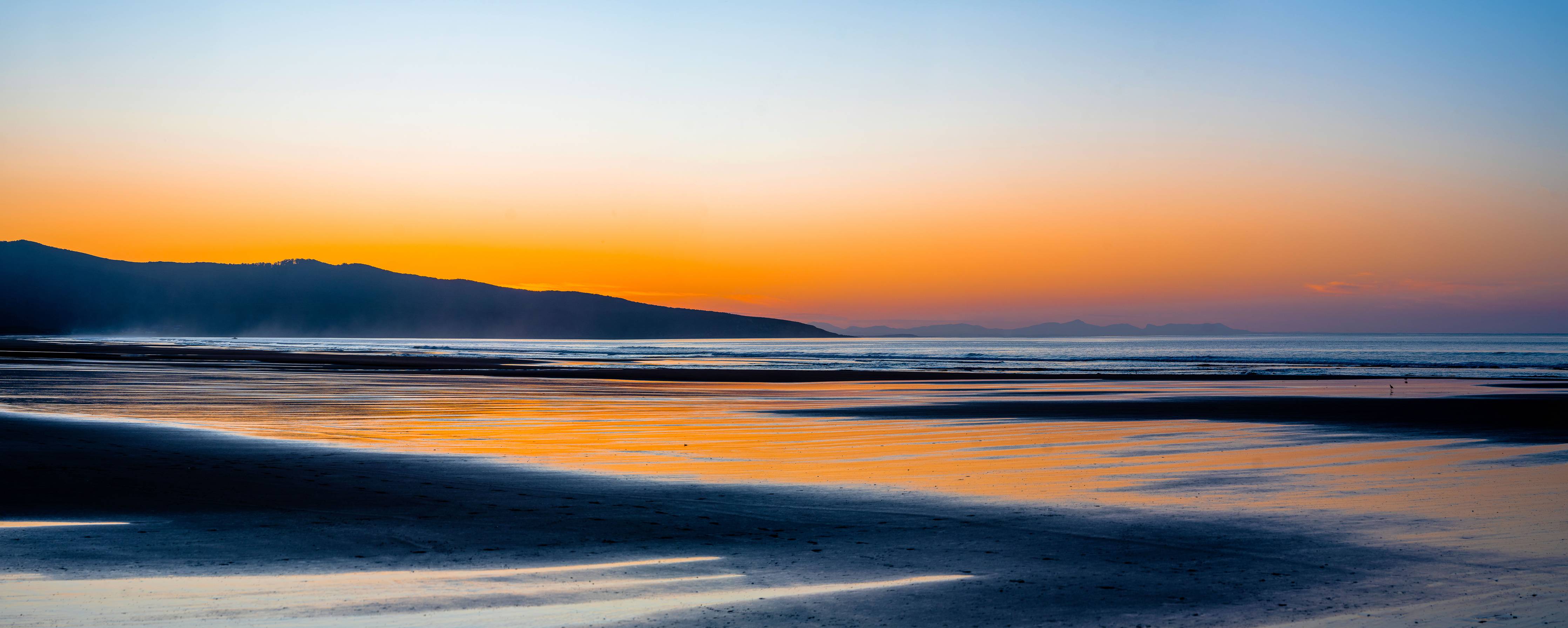 Wandverkleidung Bad-Sonnenuntergang am Strand mit sanften Wellen