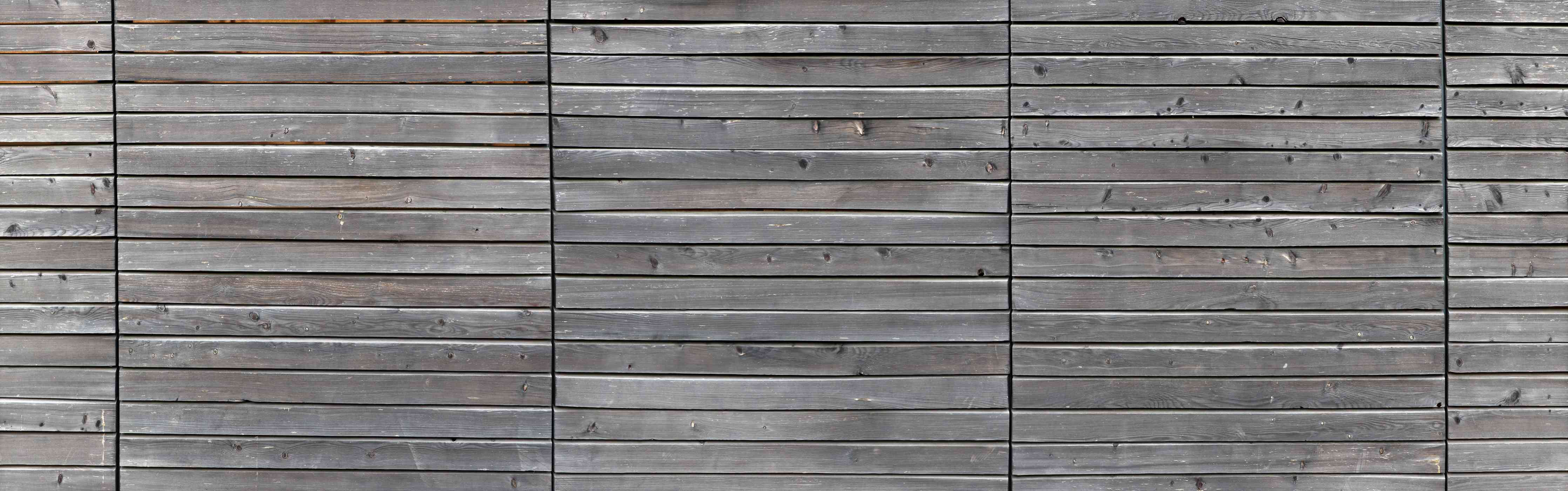 Wandverkleidung Flur-Langer grauer Holzzaun