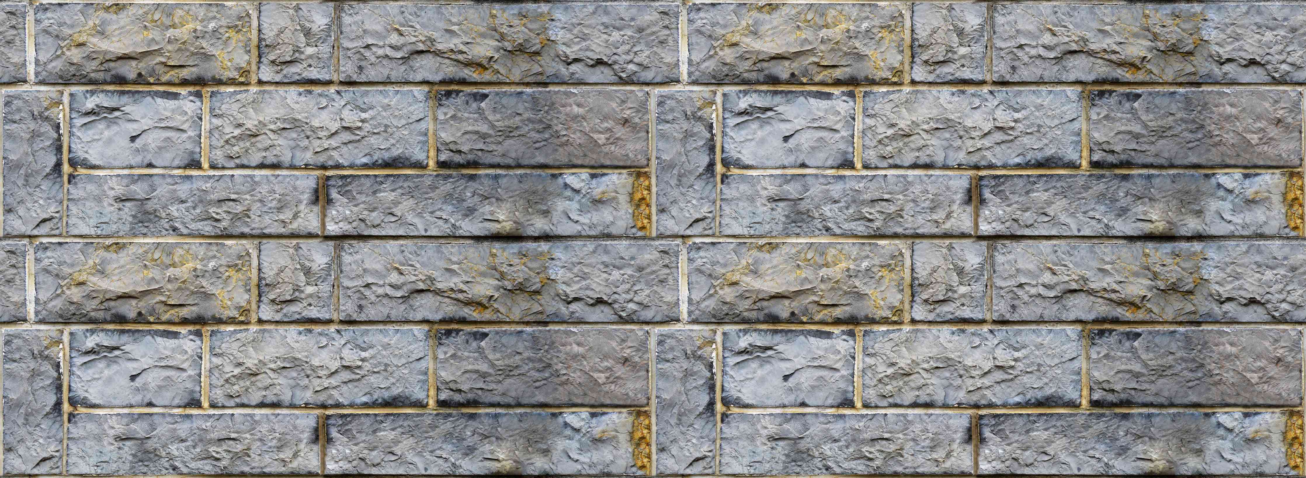 Wandverkleidung Wohnzimmer-Graue Schnittsteinmauer