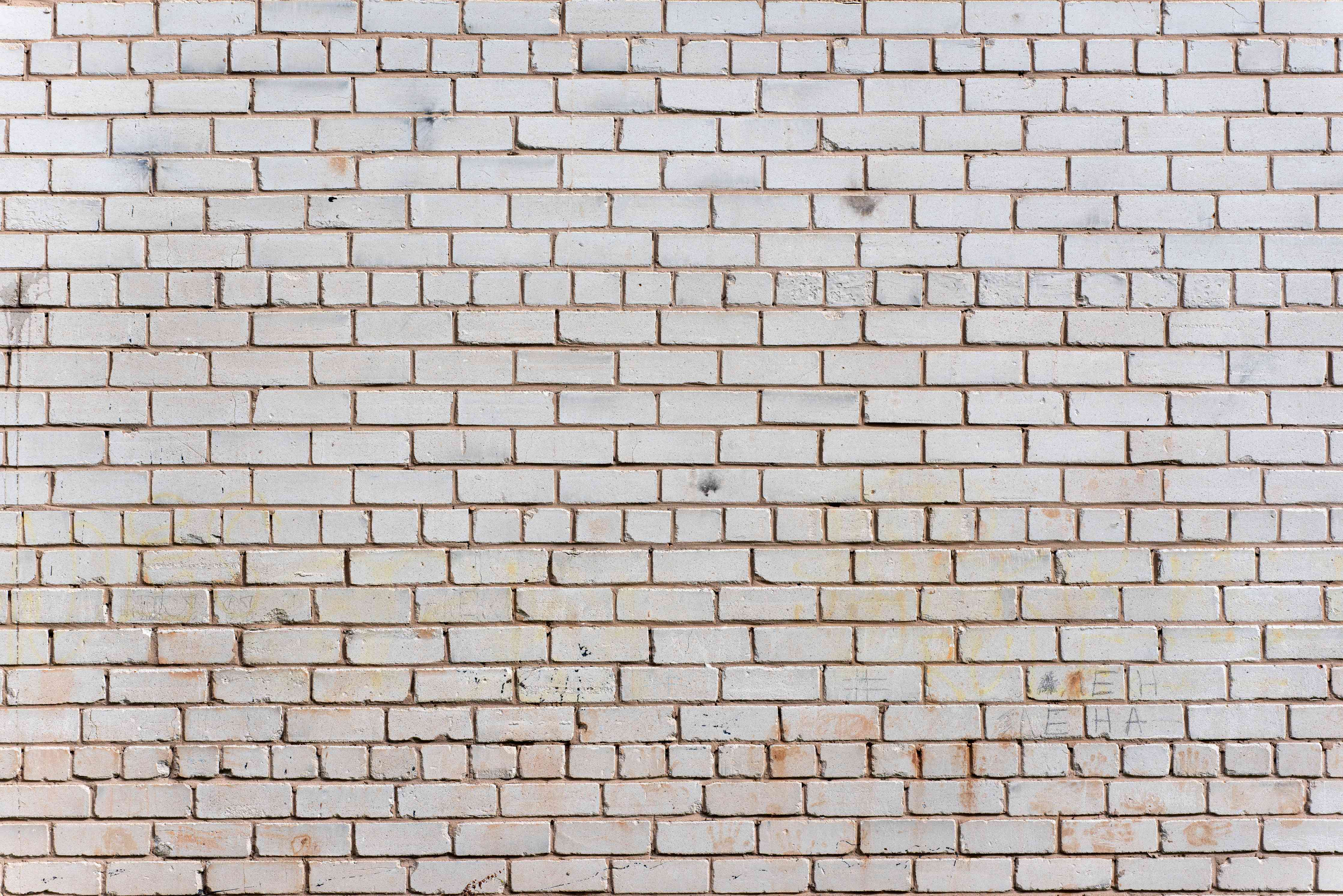 Wandverkleidung Wohnzimmer-Weiße Ziegelwand mit zarten Grautönen - realistische Textur