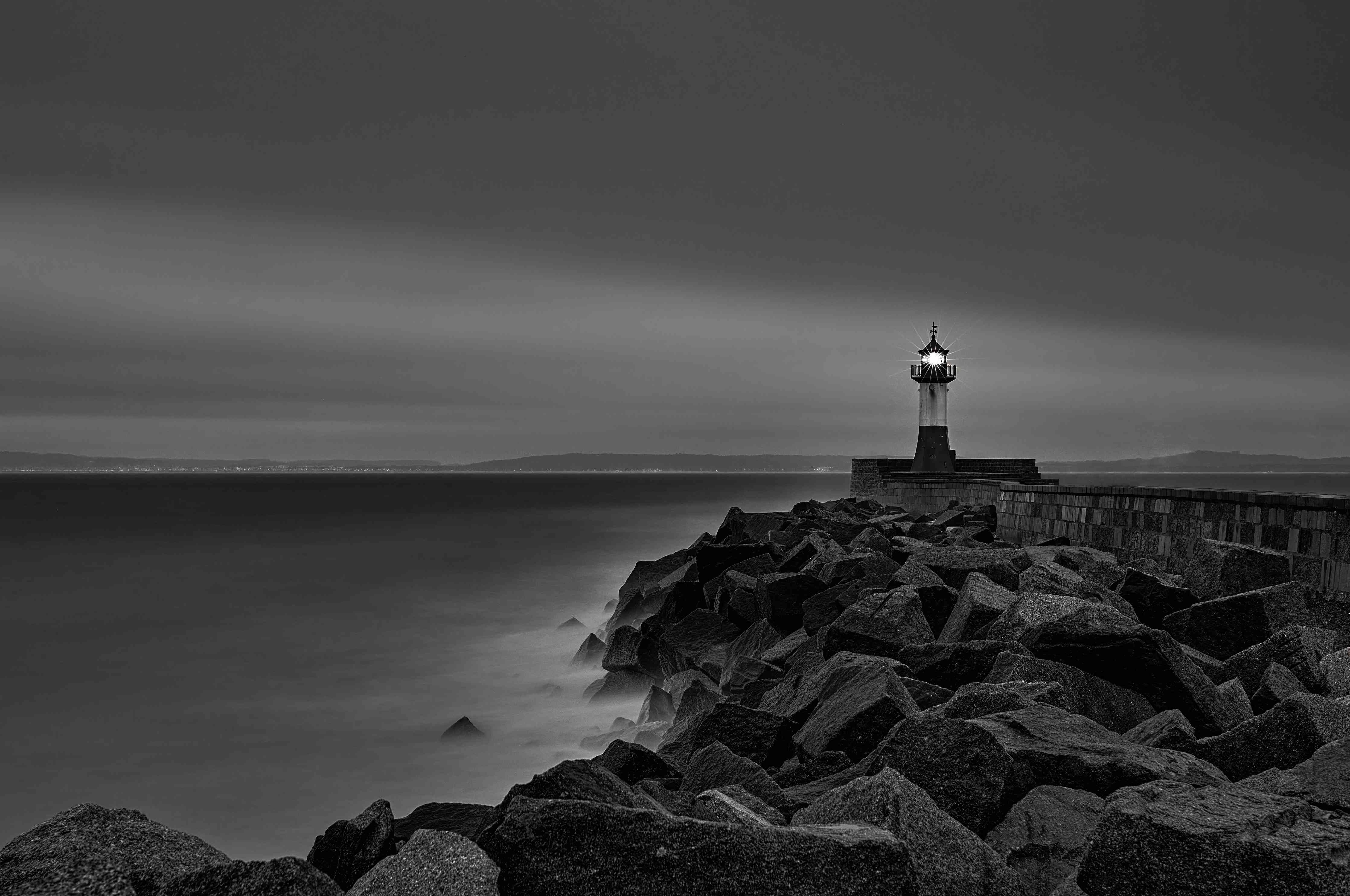 Große Wandbilder-Leuchtturm an der Küste bei Nacht in Schwarz-Weiß