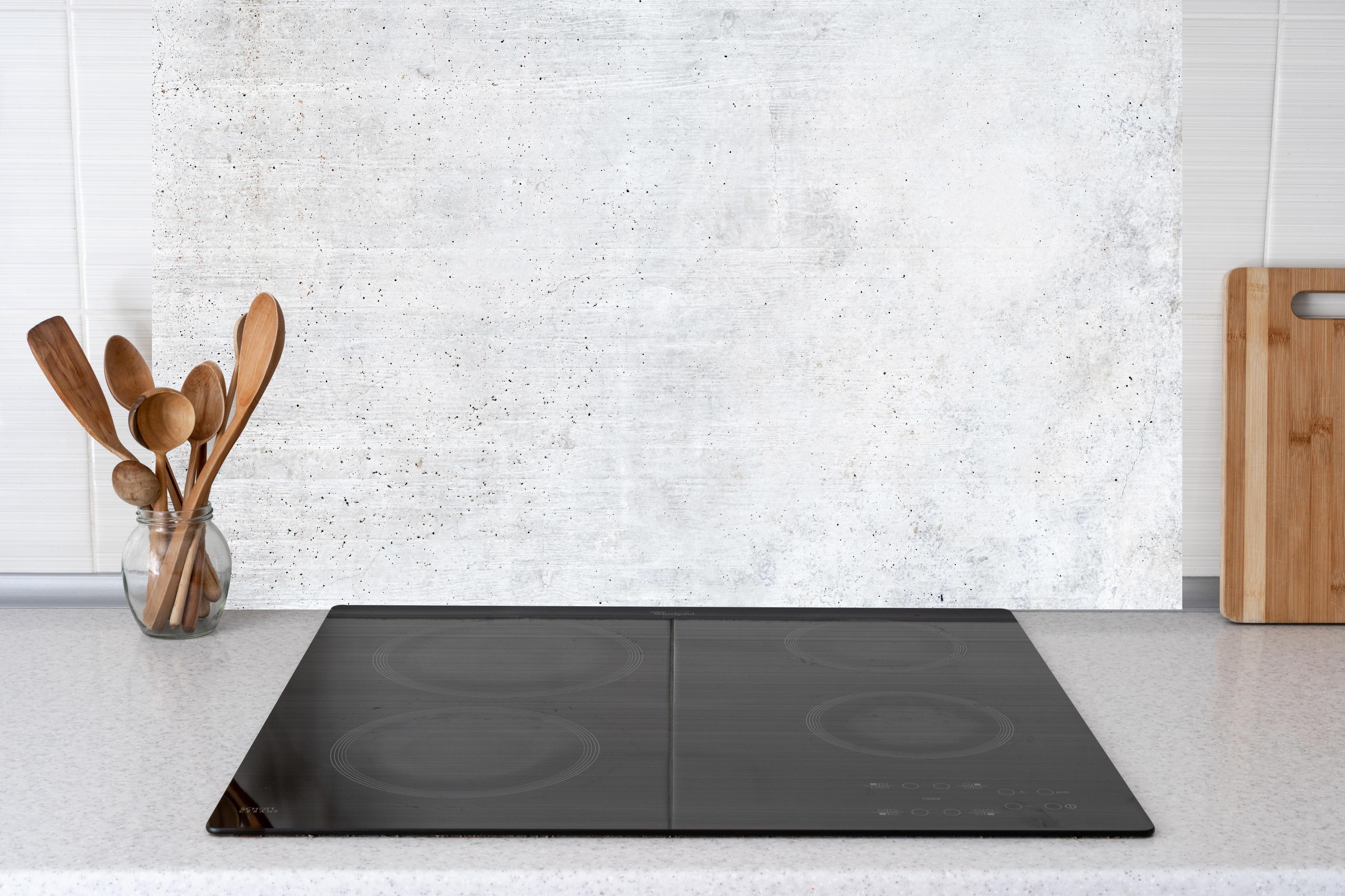 Küche - Einfache Textur einer weißen Wand hinter weißen Hochglanz-Küchenregalen und schwarzem Wasserhahn