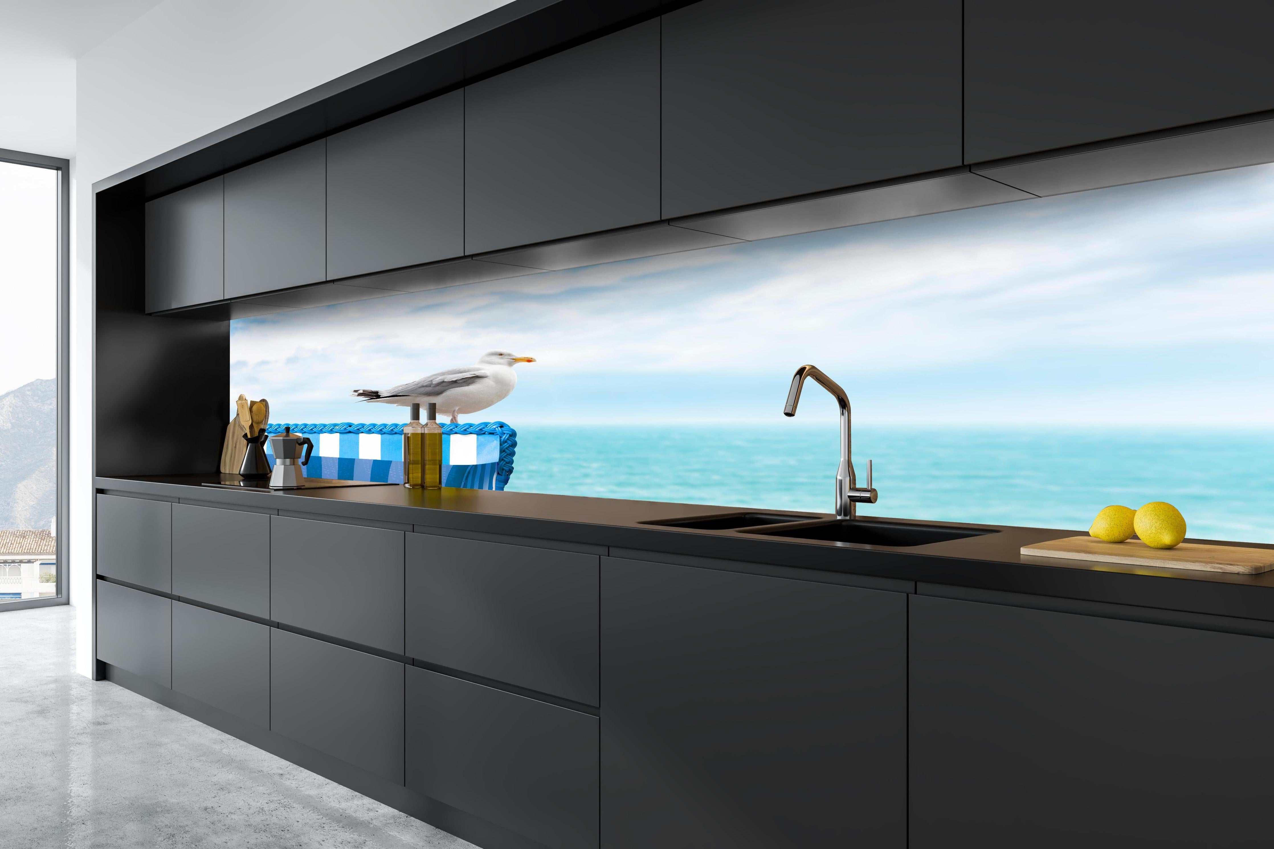 Küche - Elegant Seagull Perched on Blue Beach Chair by the Tranquil Ocean hinter weißen Hochglanz-Küchenregalen und schwarzem Wasserhahn