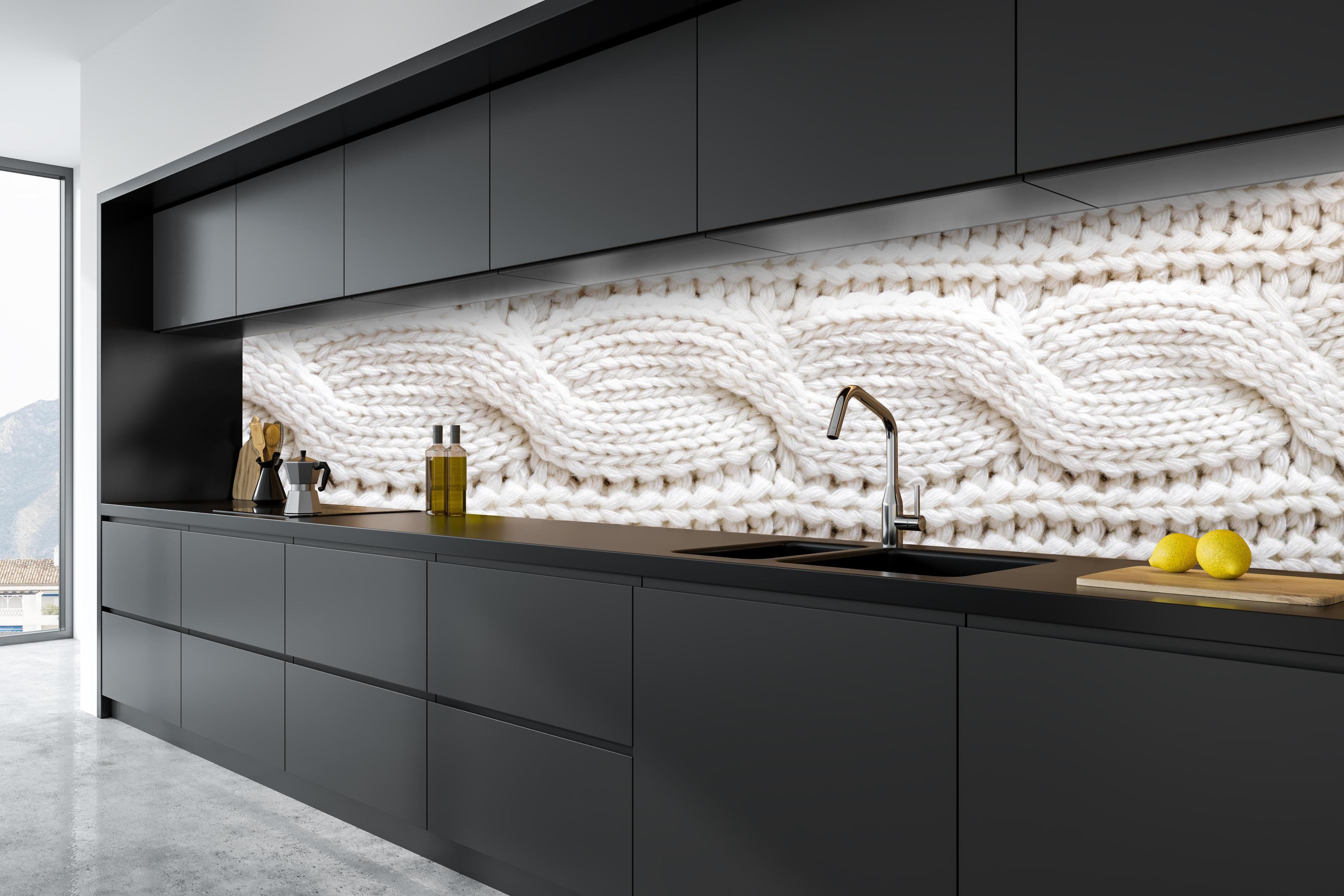 Küche - Elegante weiße Stricktextur aus Wolle hinter weißen Hochglanz-Küchenregalen und schwarzem Wasserhahn