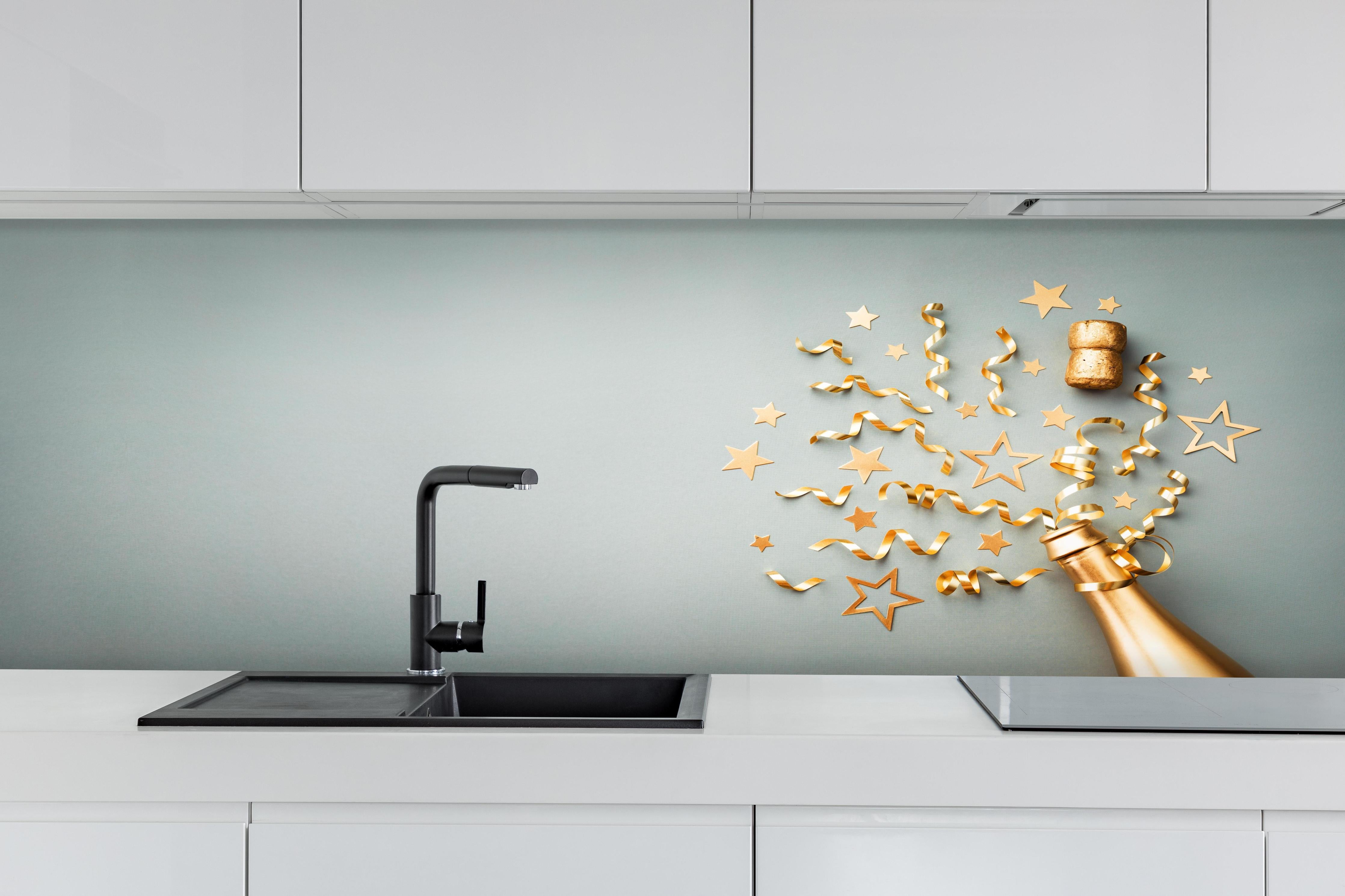Küche - Goldene Champagnerflasche im Sylvester design hinter weißen Hochglanz-Küchenregalen und schwarzem Wasserhahn