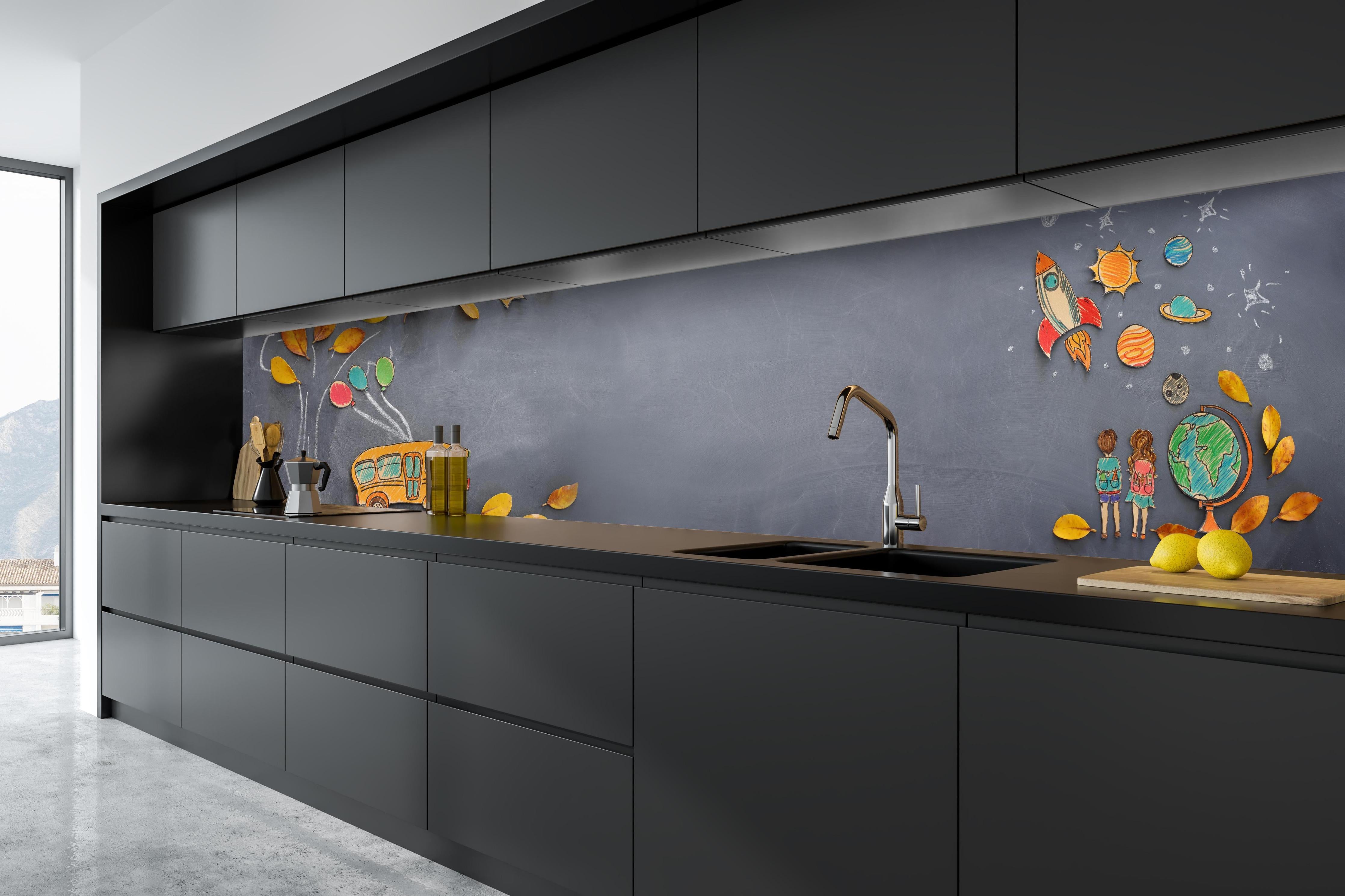 Küche - Herbstleaves und Schulbus auf Tafel hinter weißen Hochglanz-Küchenregalen und schwarzem Wasserhahn