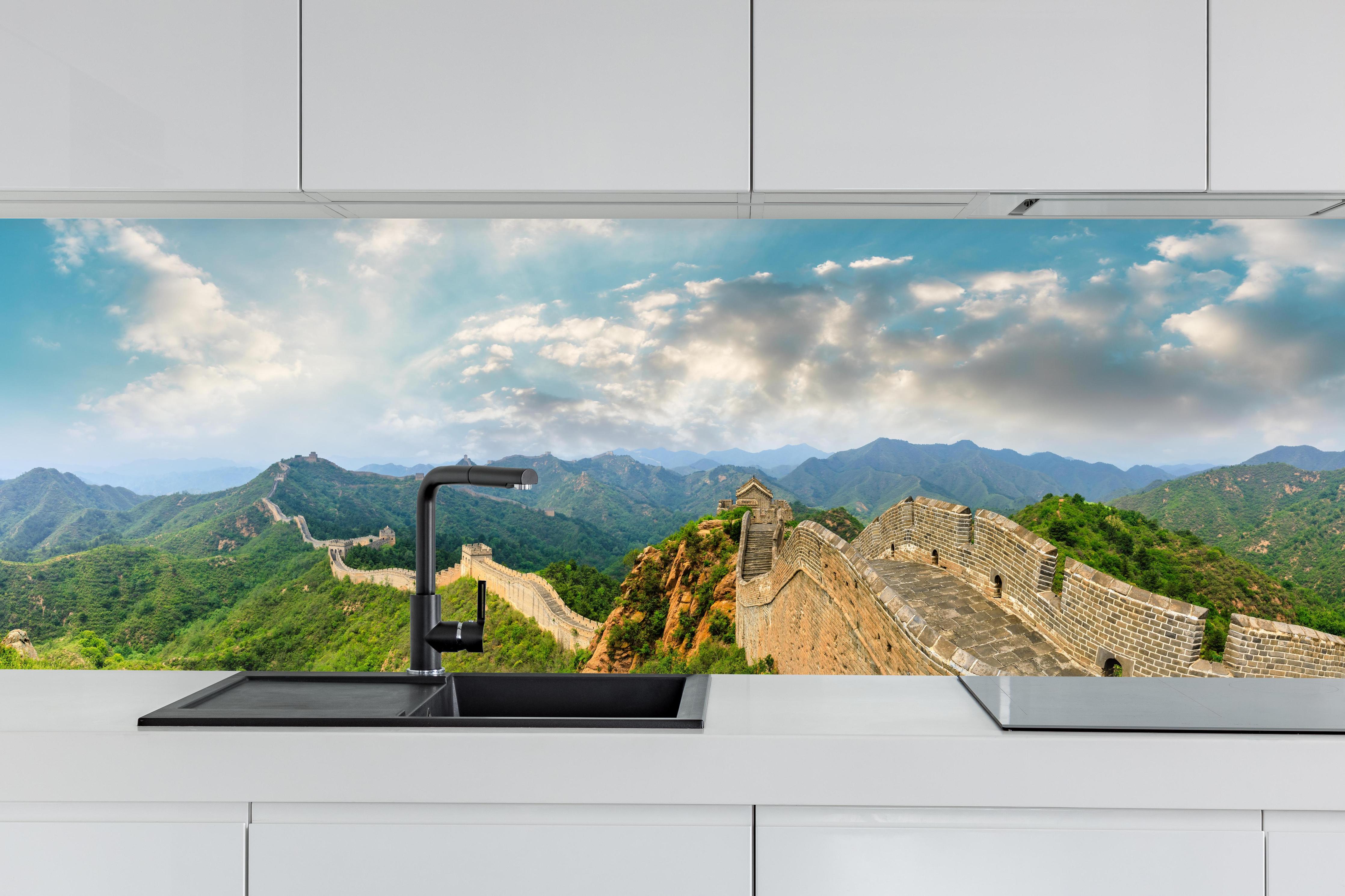 Küche - Chinesische Mauer im Farbenspiel von Himmel und Natur hinter weißen Hochglanz-Küchenregalen und schwarzem Wasserhahn