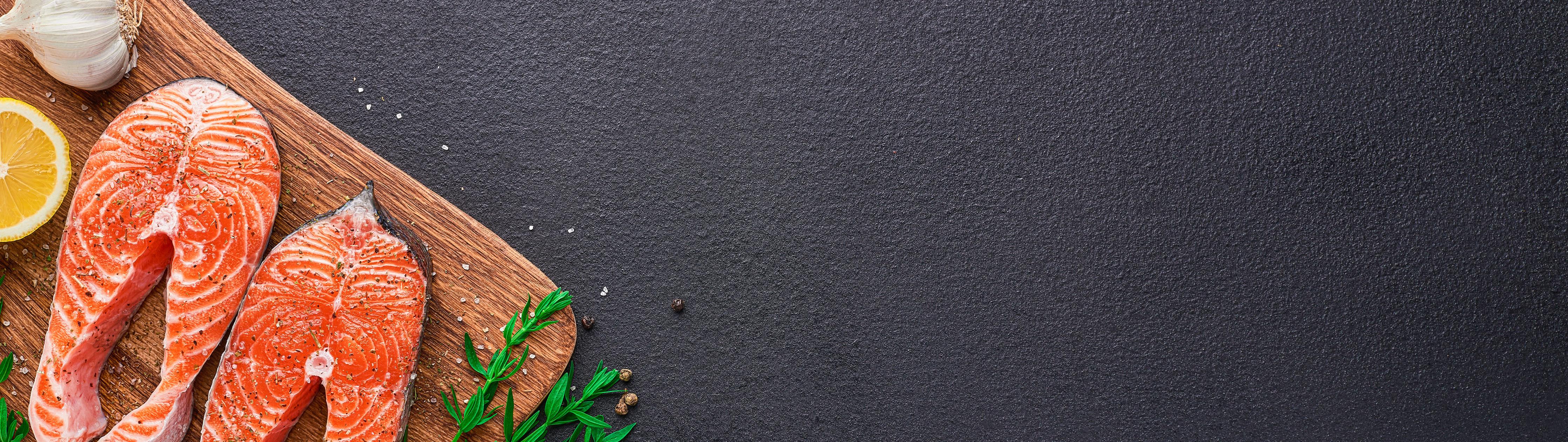 Küchenrückwand-Lachssteaks auf Holzbrett