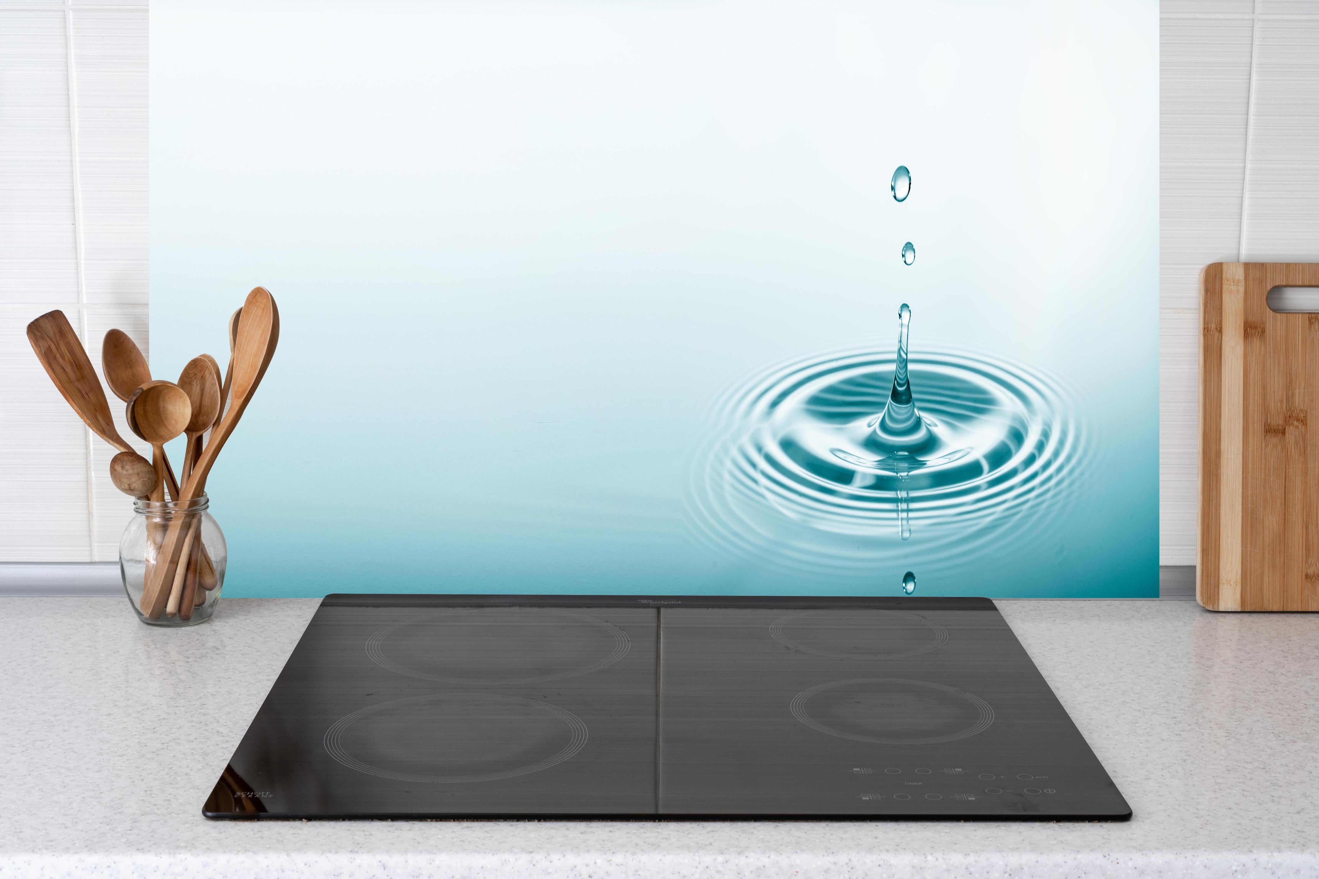 Küche - Türkis-Weißer Wassertropfen hinter Cerankochfeld und Holz-Kochutensilien