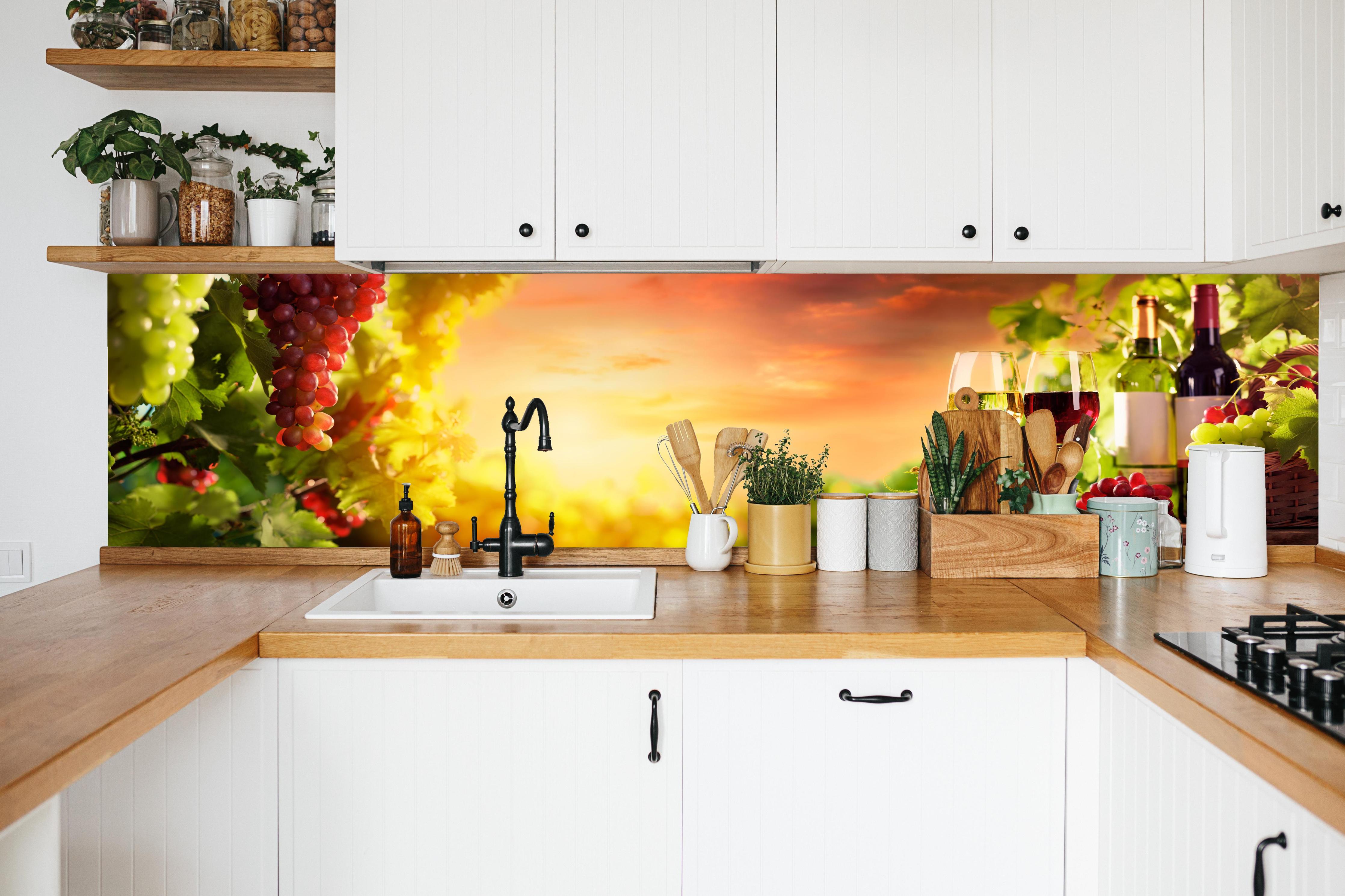 Küche - Weintrauben und Wein im Sonnenuntergang in weißer Küche hinter Gewürzen und Kochlöffeln aus Holz