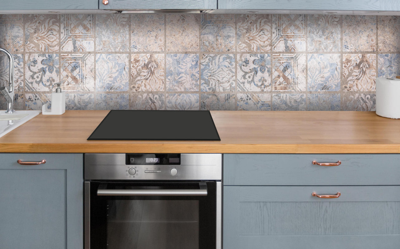 Küche - Altes blau-braun Patchwork Motiv über polierter Holzarbeitsplatte mit Cerankochfeld