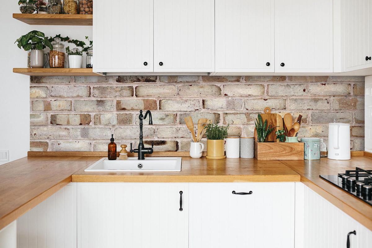 Küche - Braune verschimmelte Ziegelmauer in weißer Küche hinter Gewürzen und Kochlöffeln aus Holz