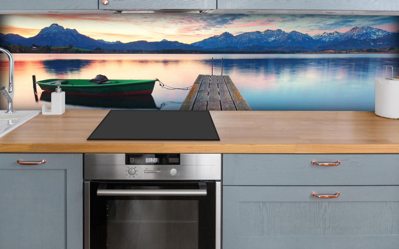 Küche - Kleines Boot am Bergsee über polierter Holzarbeitsplatte mit Cerankochfeld