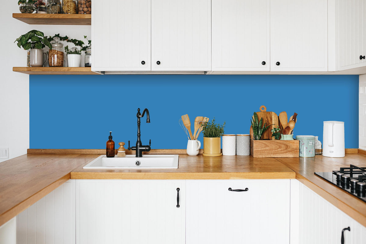 Küche - RAL 5012 (Hellblau) in weißer Küche hinter Gewürzen und Kochlöffeln aus Holz