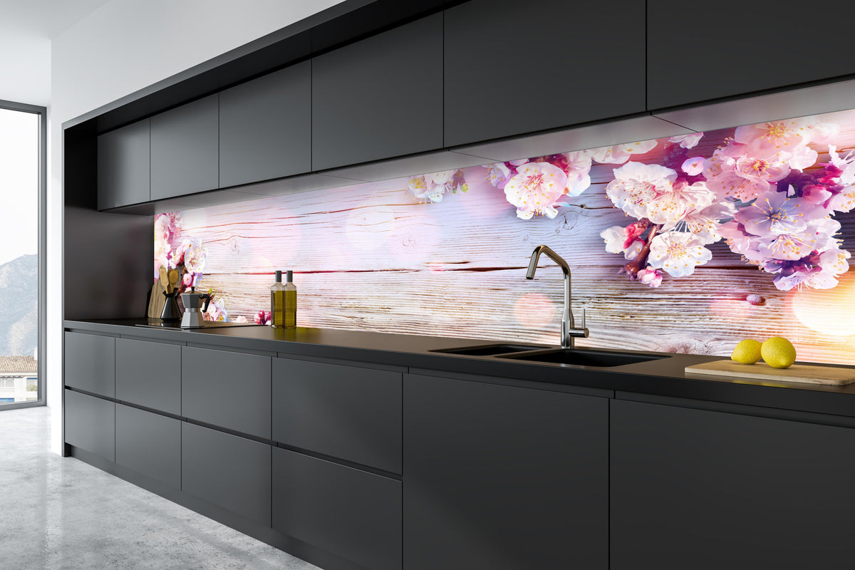 Küche - Rosa Blüten auf Holzplatte in tiefschwarzer matt-premium Einbauküche