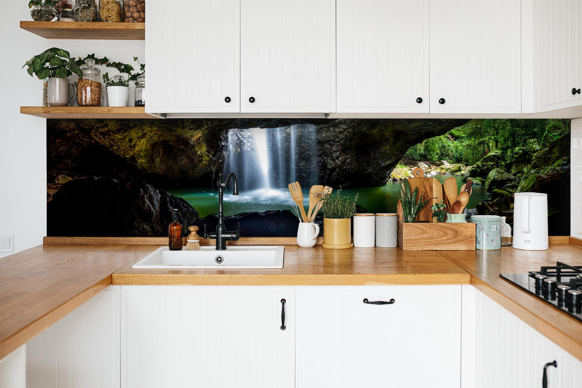 Küche - Wasserfall in der Höhle in weißer Küche hinter Gewürzen und Kochlöffeln aus Holz