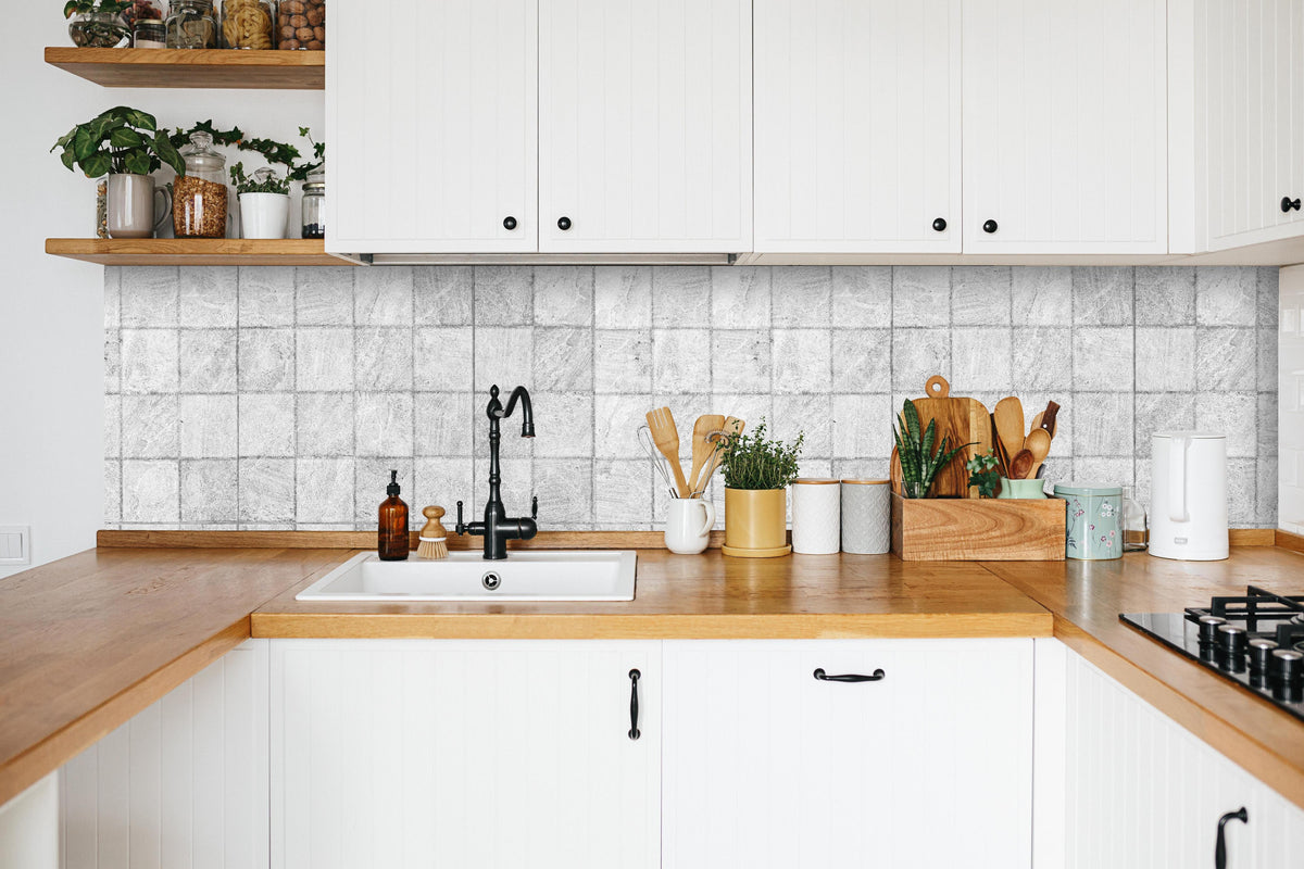 Küche - Weiße quadratische Stein Fliesen in weißer Küche hinter Gewürzen und Kochlöffeln aus Holz