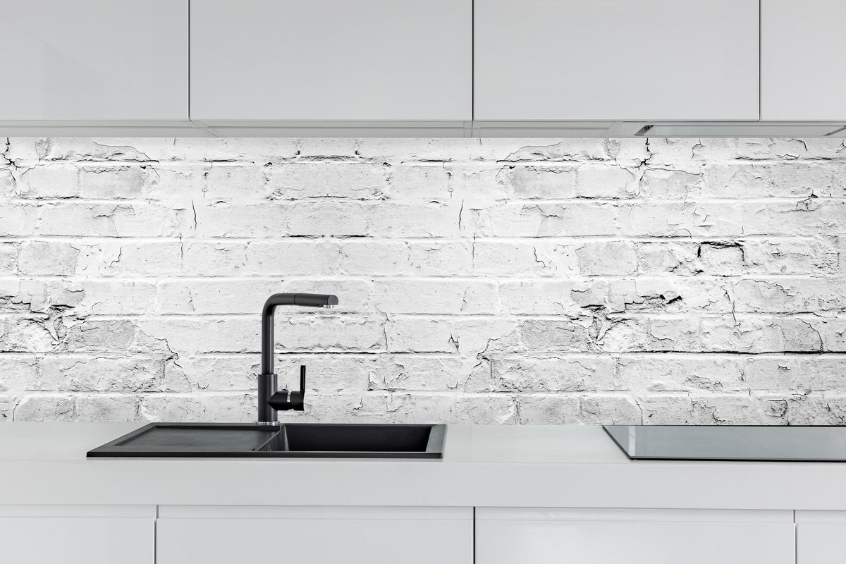 Küche - Weißer rustikaler Mauerwerk hinter weißen Hochglanz-Küchenregalen und schwarzem Wasserhahn