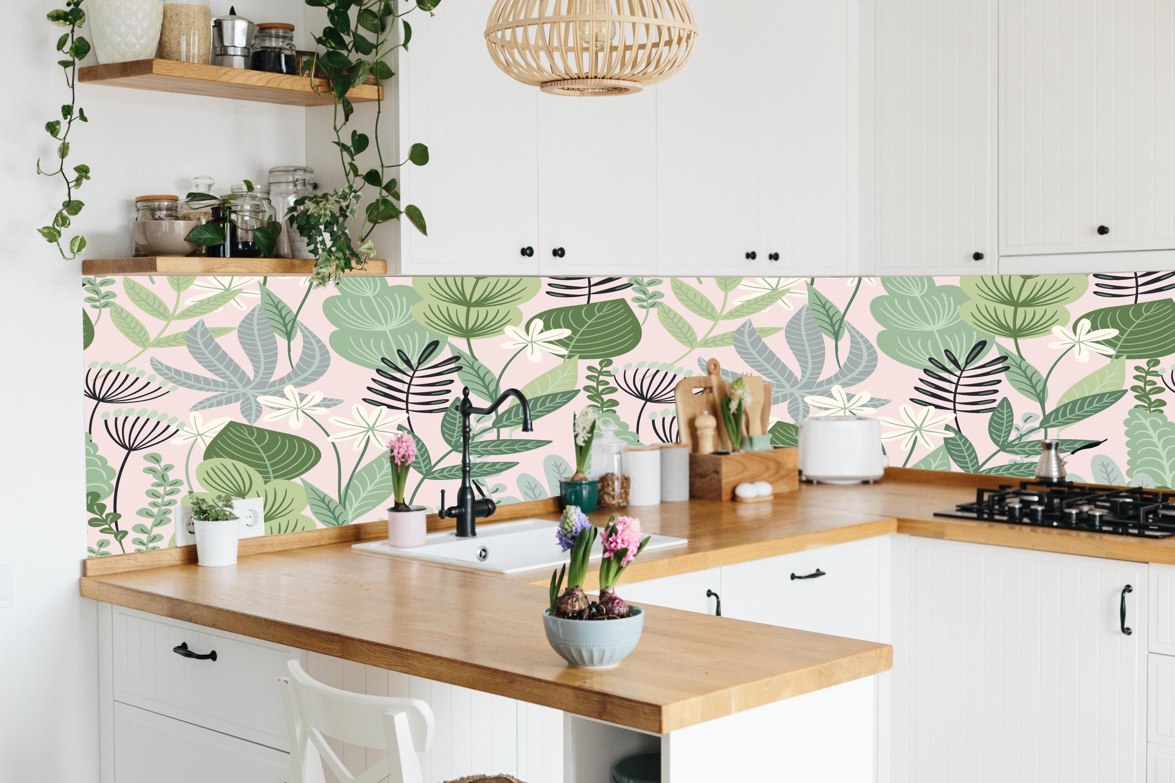 Küche - Pastellfarbenes Blumenmuster in Grün und Rosa hinter weißen Hochglanz-Küchenregalen und schwarzem Wasserhahn