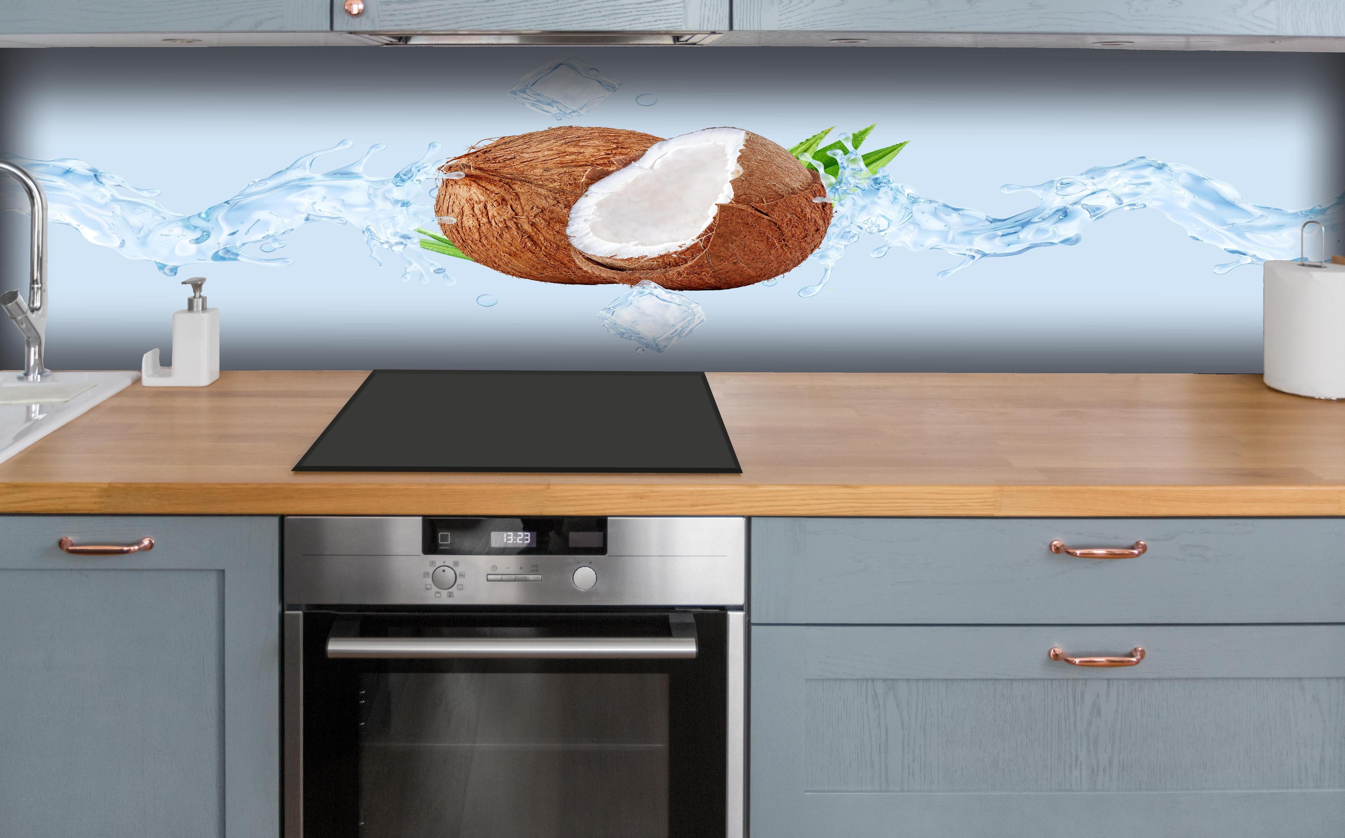 Küche - Spritzige Kokosnüsse  hinter weißen Hochglanz-Küchenregalen und schwarzem Wasserhahn