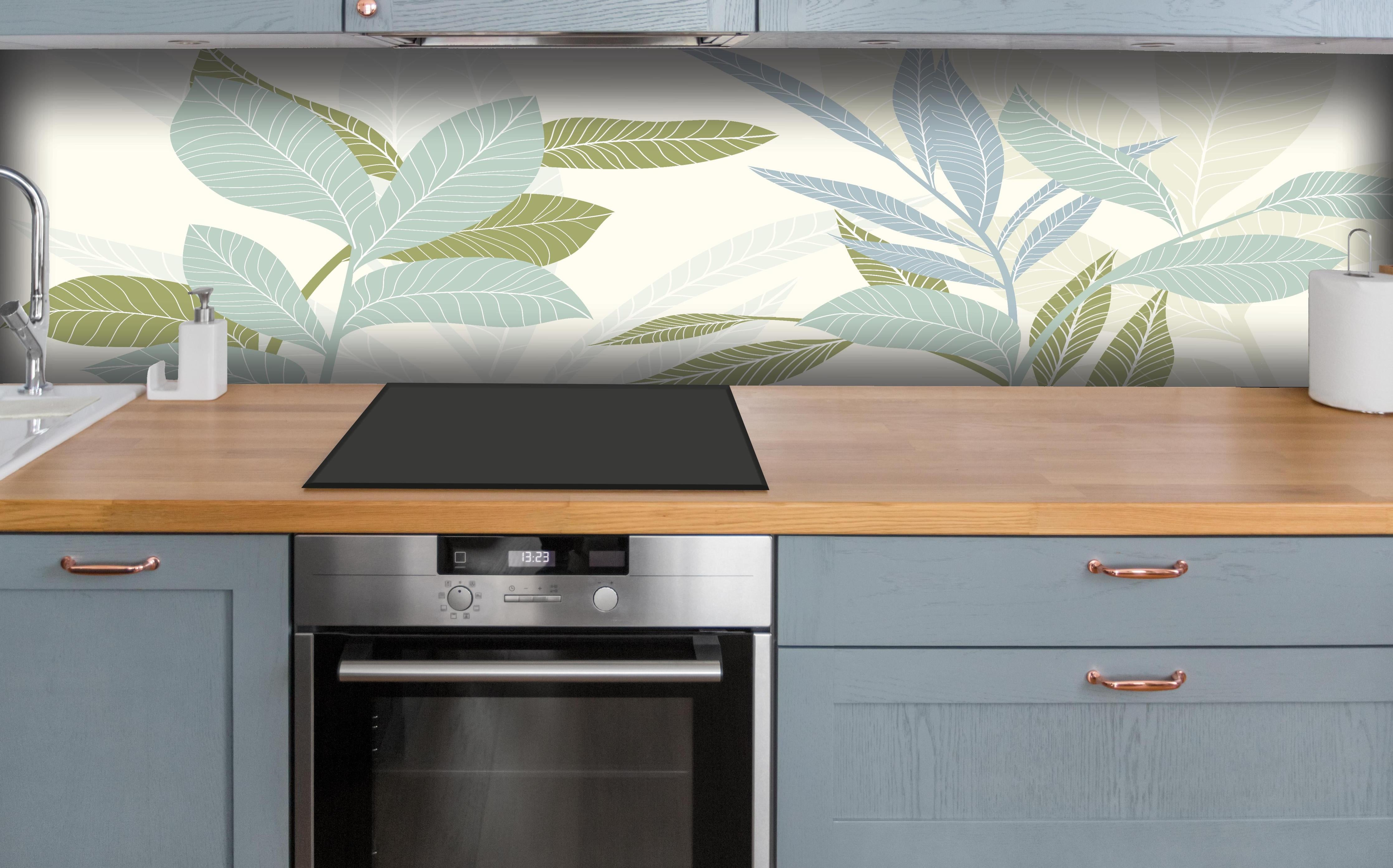 Küche - Stilvolles Blatt-Design in Pastelltönen hinter weißen Hochglanz-Küchenregalen und schwarzem Wasserhahn