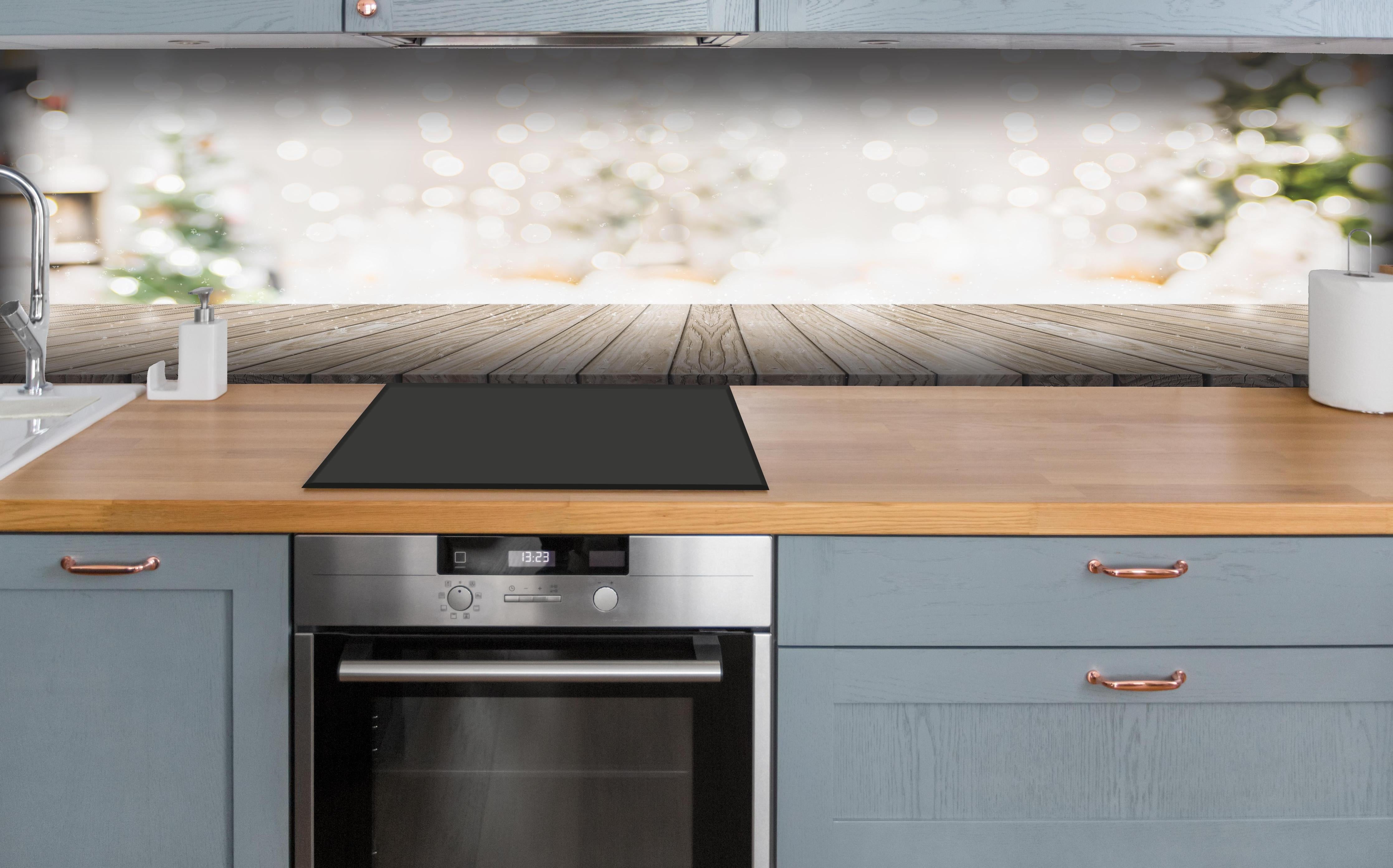 Küche - Weihnachtstimmung hinter weißen Hochglanz-Küchenregalen und schwarzem Wasserhahn