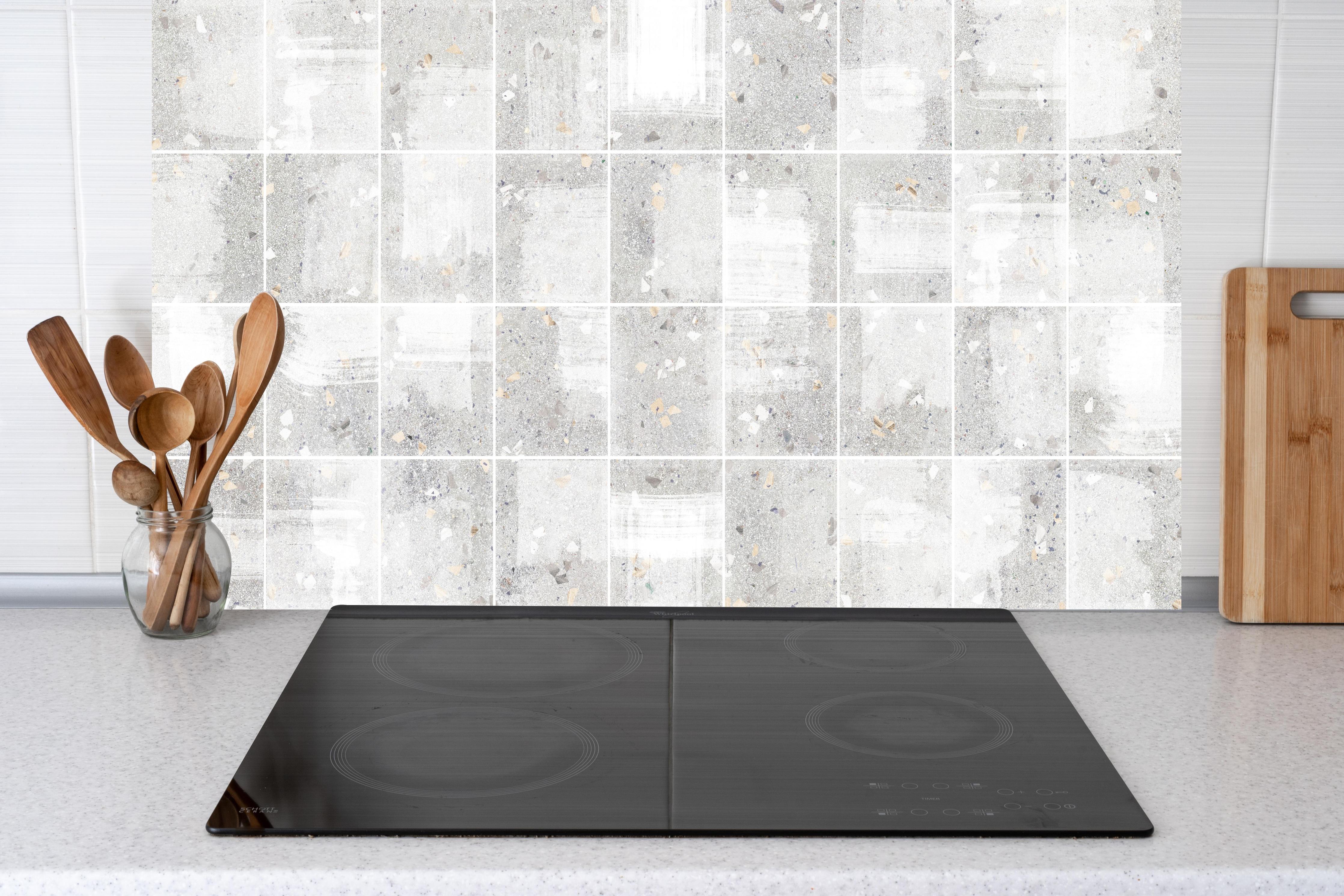 Küche - Weißes Fliesenmuster - Terrazzo Struktur  hinter weißen Hochglanz-Küchenregalen und schwarzem Wasserhahn