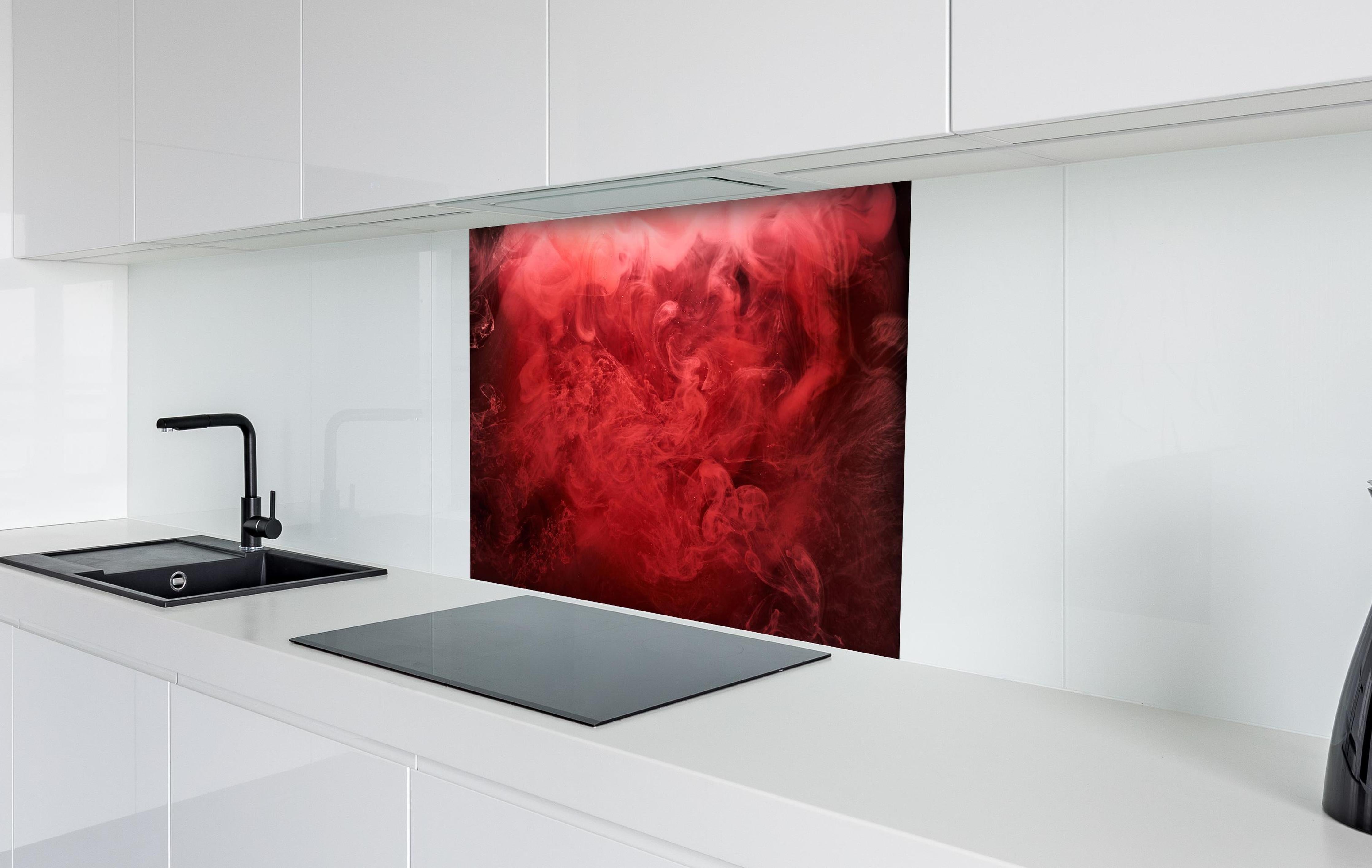 Spritzschutz - Abstrakter roter Ozean hinter einem Cerankochfeld zwischen Holz-Kochutensilien
