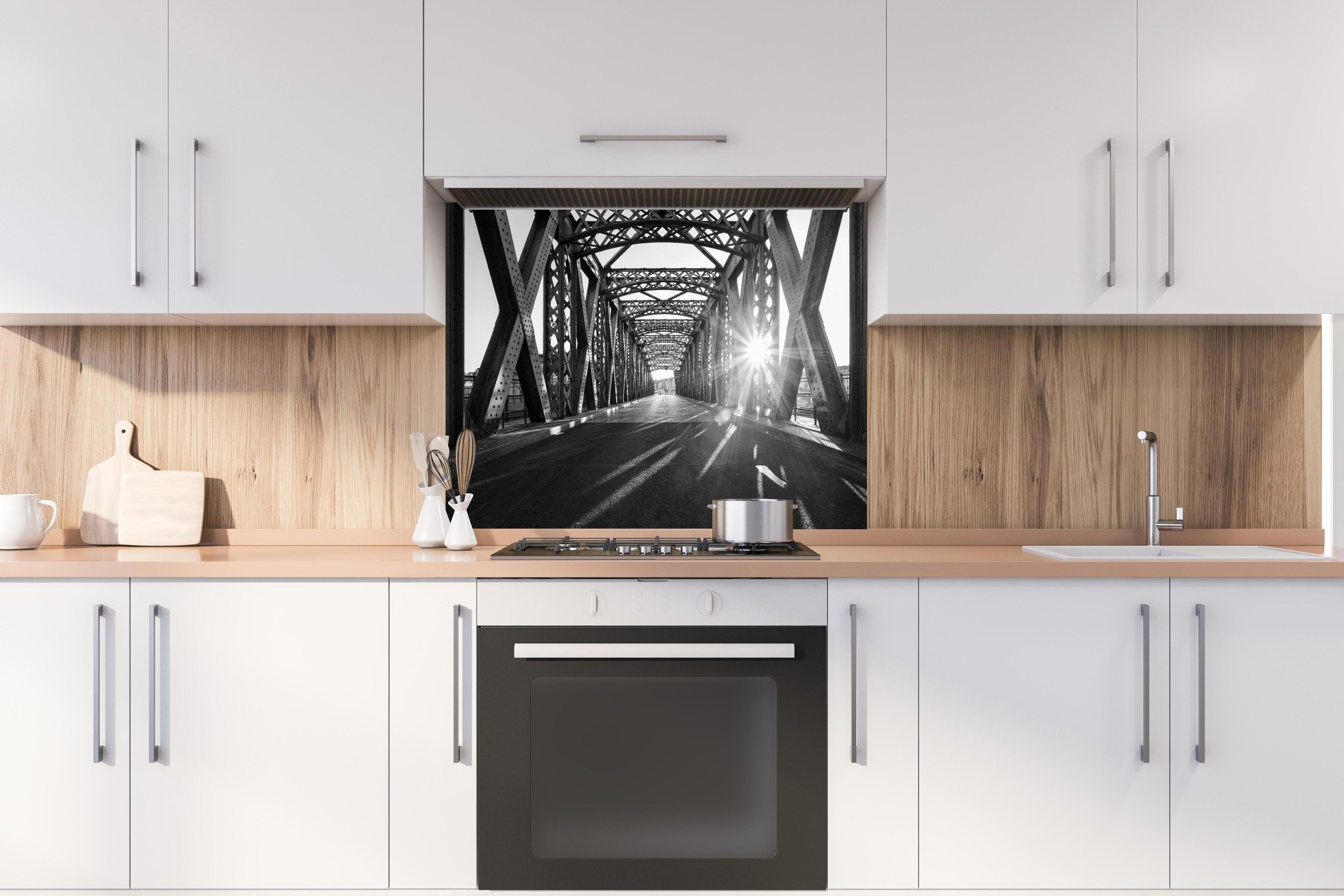 Spritzschutz - Alte Stadtbrücke hinter einem Cerankochfeld zwischen Holz-Kochutensilien
