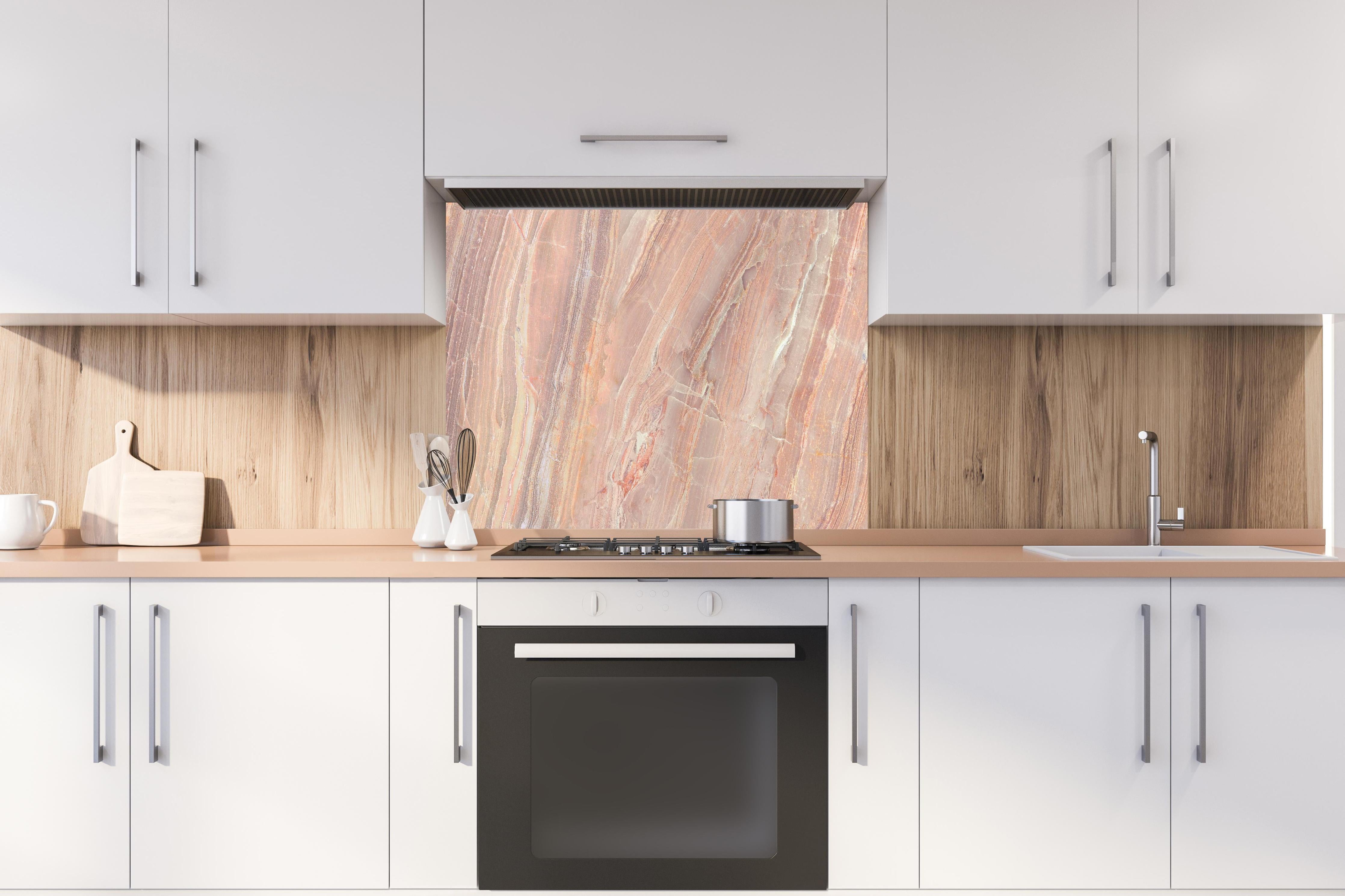 Spritzschutz - Beiges Marmor Design - Nahaufnahme hinter einem Cerankochfeld zwischen Holz-Kochutensilien
