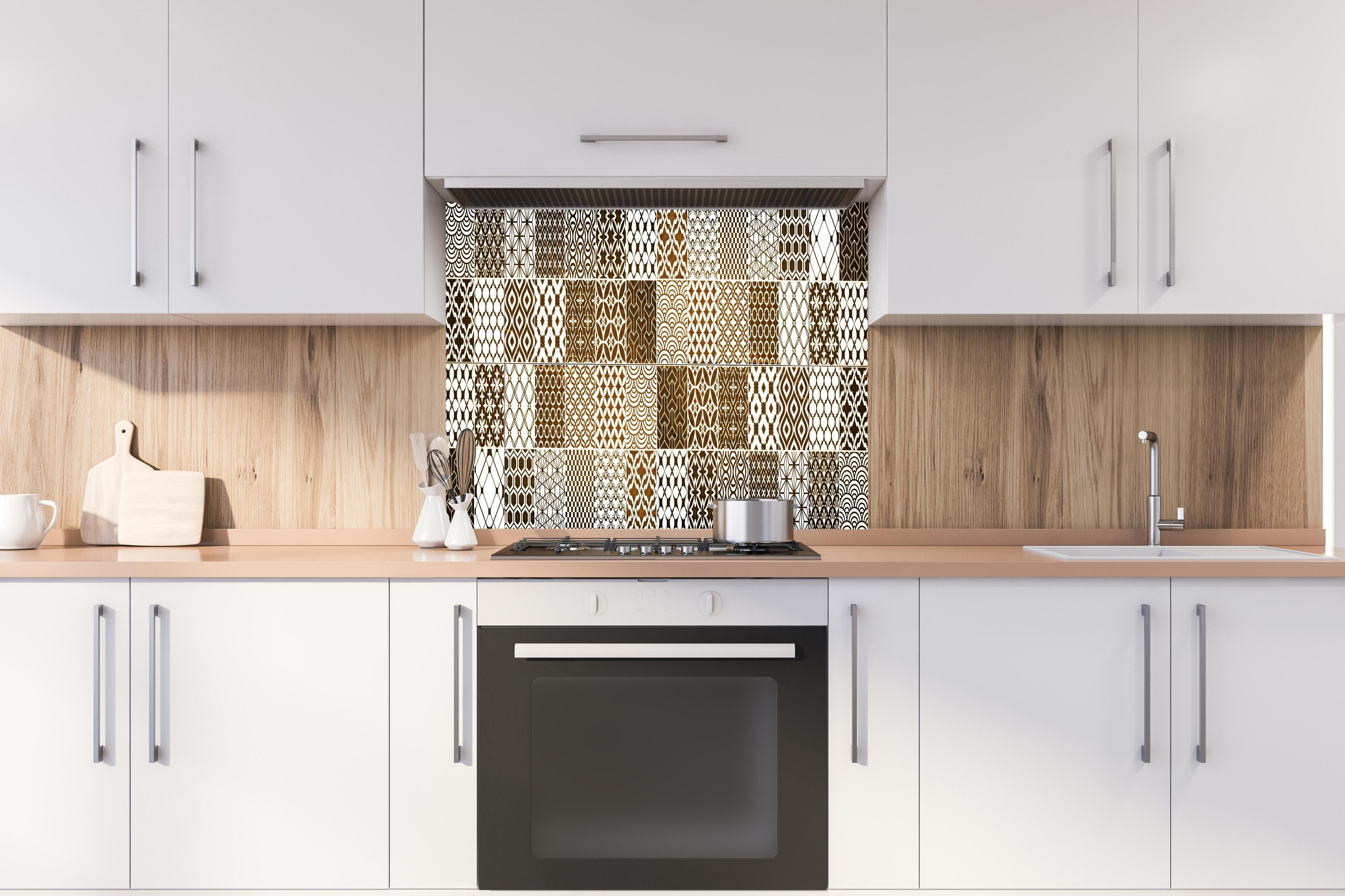 Spritzschutz - Braun-Beige geometrisch Mosaik hinter einem Cerankochfeld zwischen Holz-Kochutensilien
