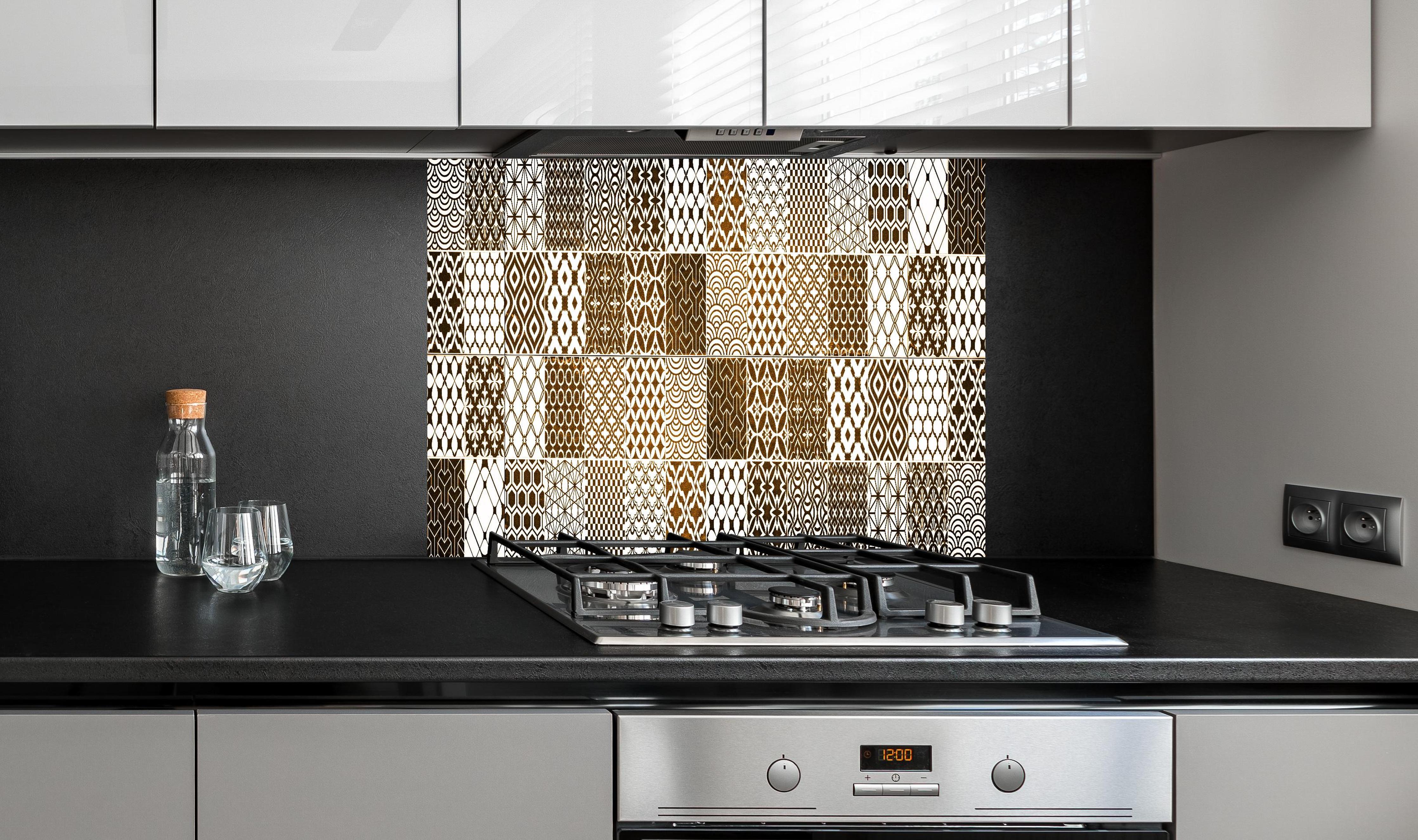 Spritzschutz - Braun-Beige geometrisch Mosaik hinter einem Cerankochfeld zwischen Holz-Kochutensilien
