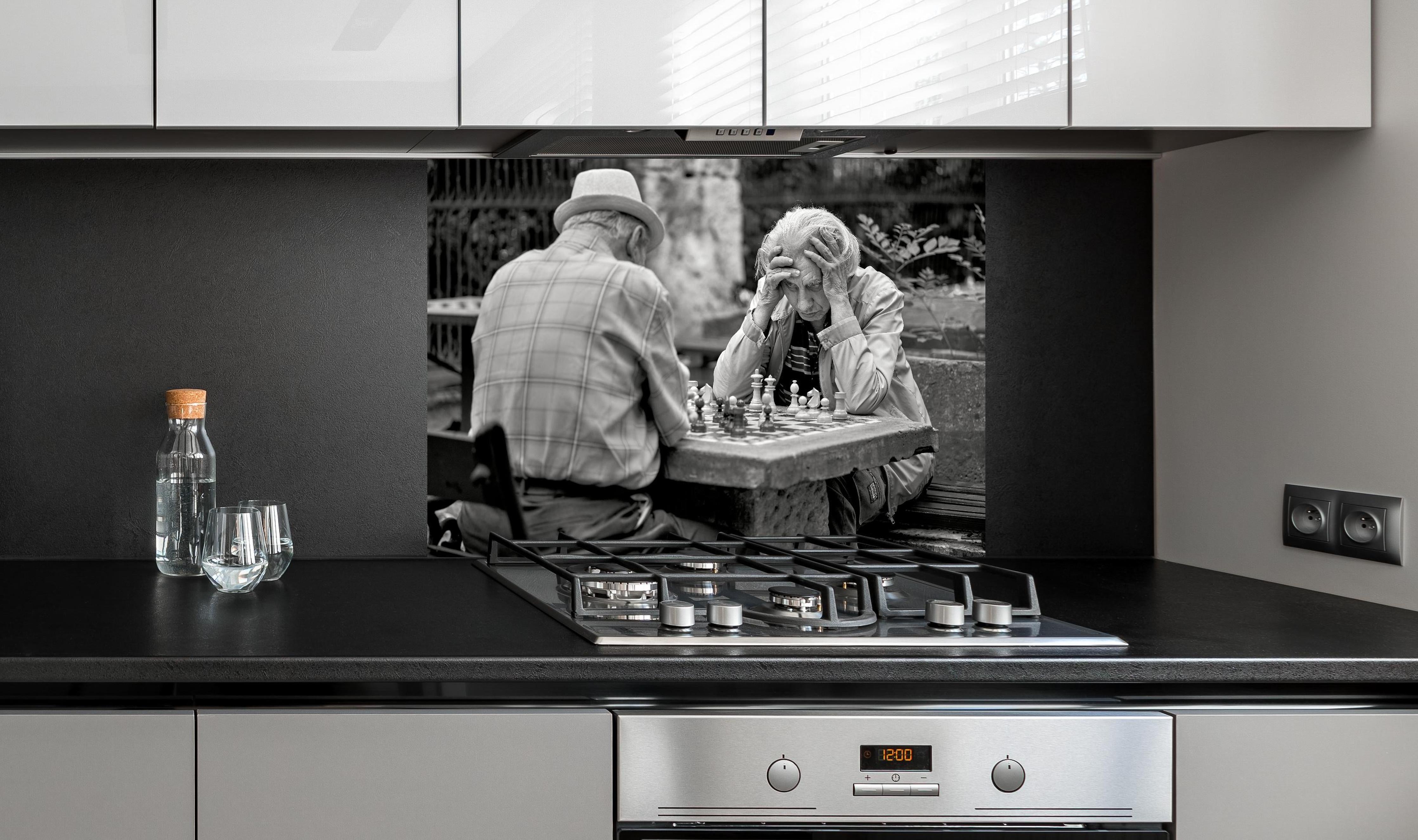 Spritzschutz - Brettspiele - Schwarz-weiß hinter einem Cerankochfeld zwischen Holz-Kochutensilien
