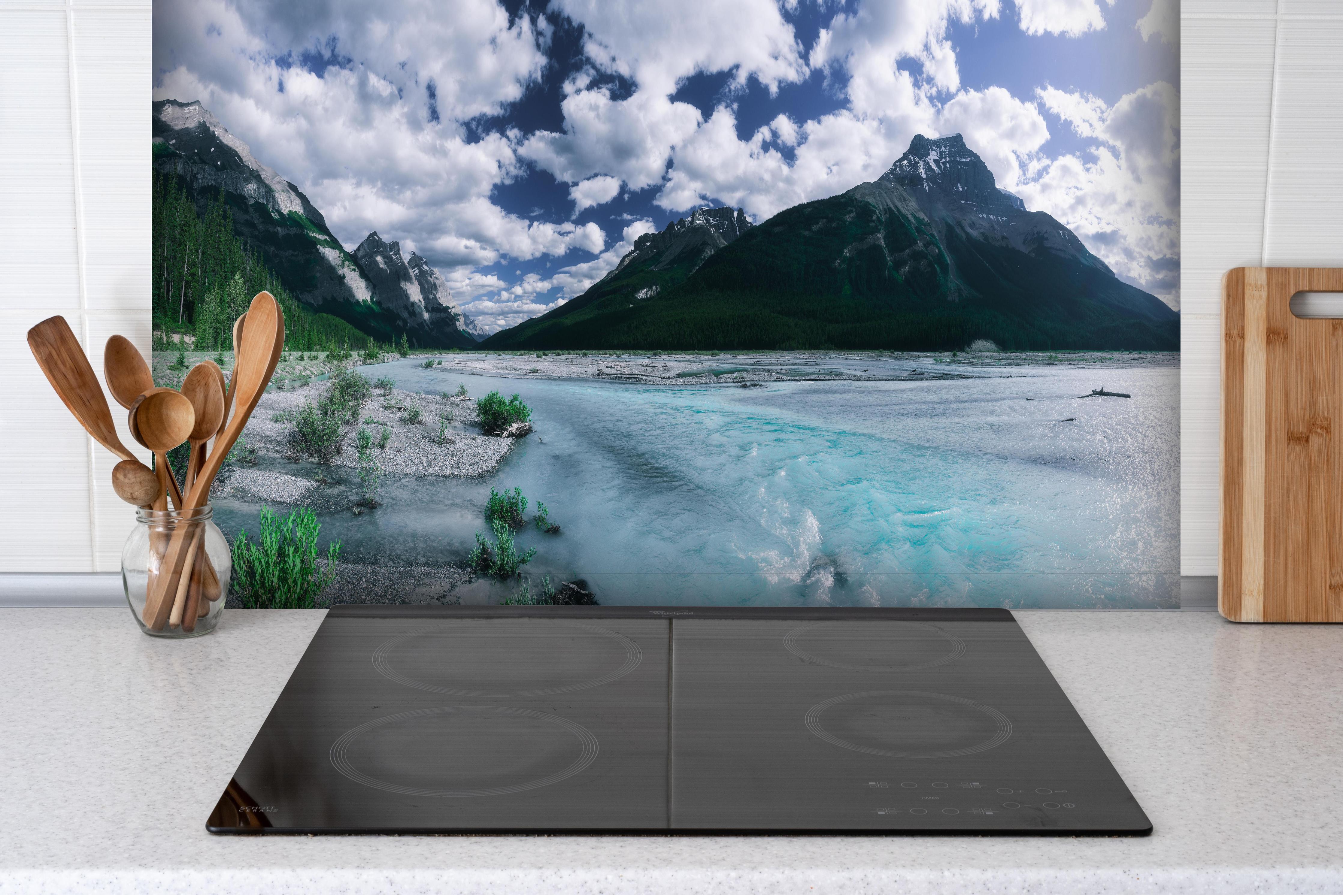 Spritzschutz - Dramatische Landschaft entlang des Icefields Parkway hinter einem Cerankochfeld zwischen Holz-Kochutensilien
